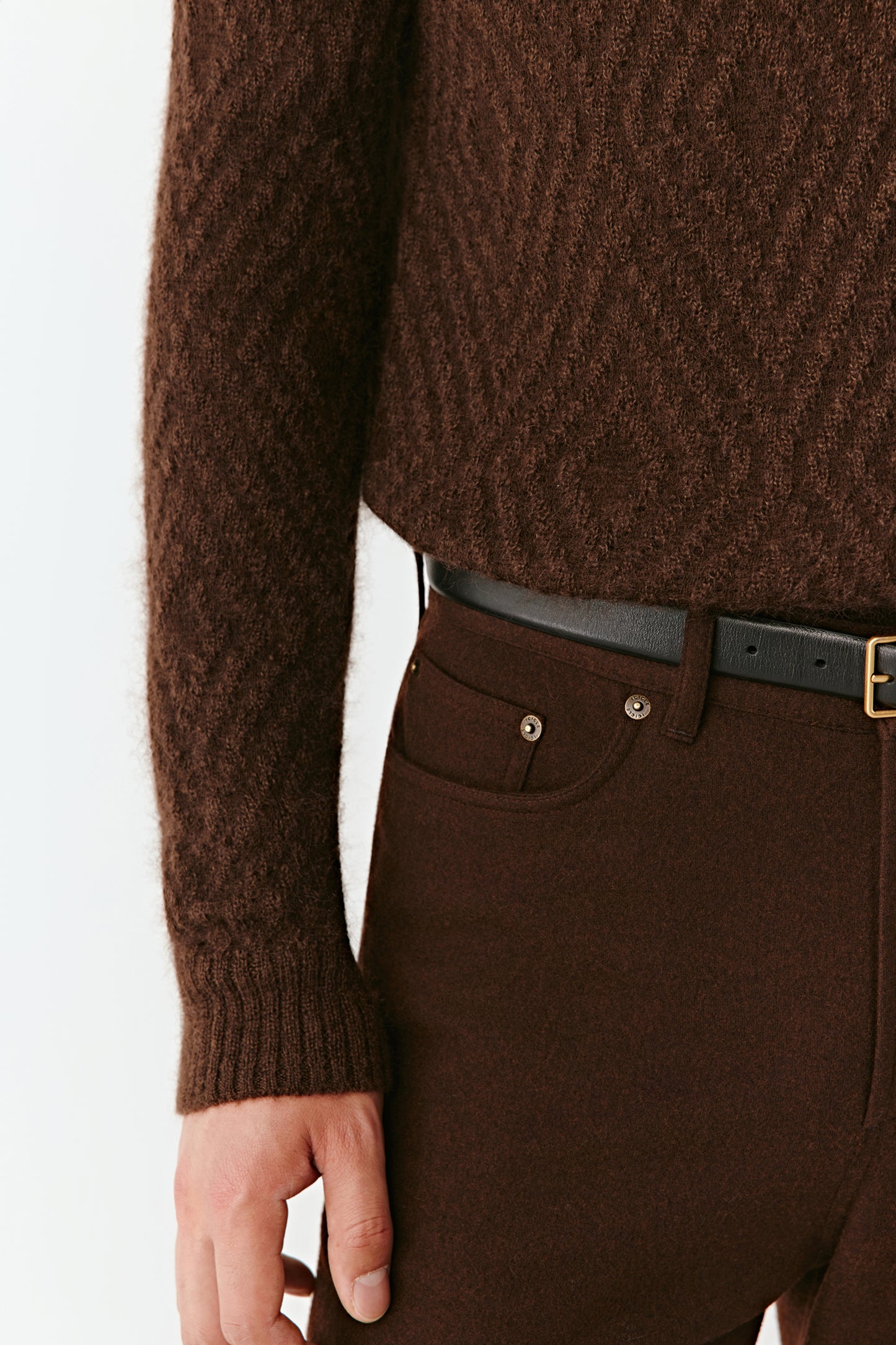 Brown textured sweater and pants with a belt on a white background