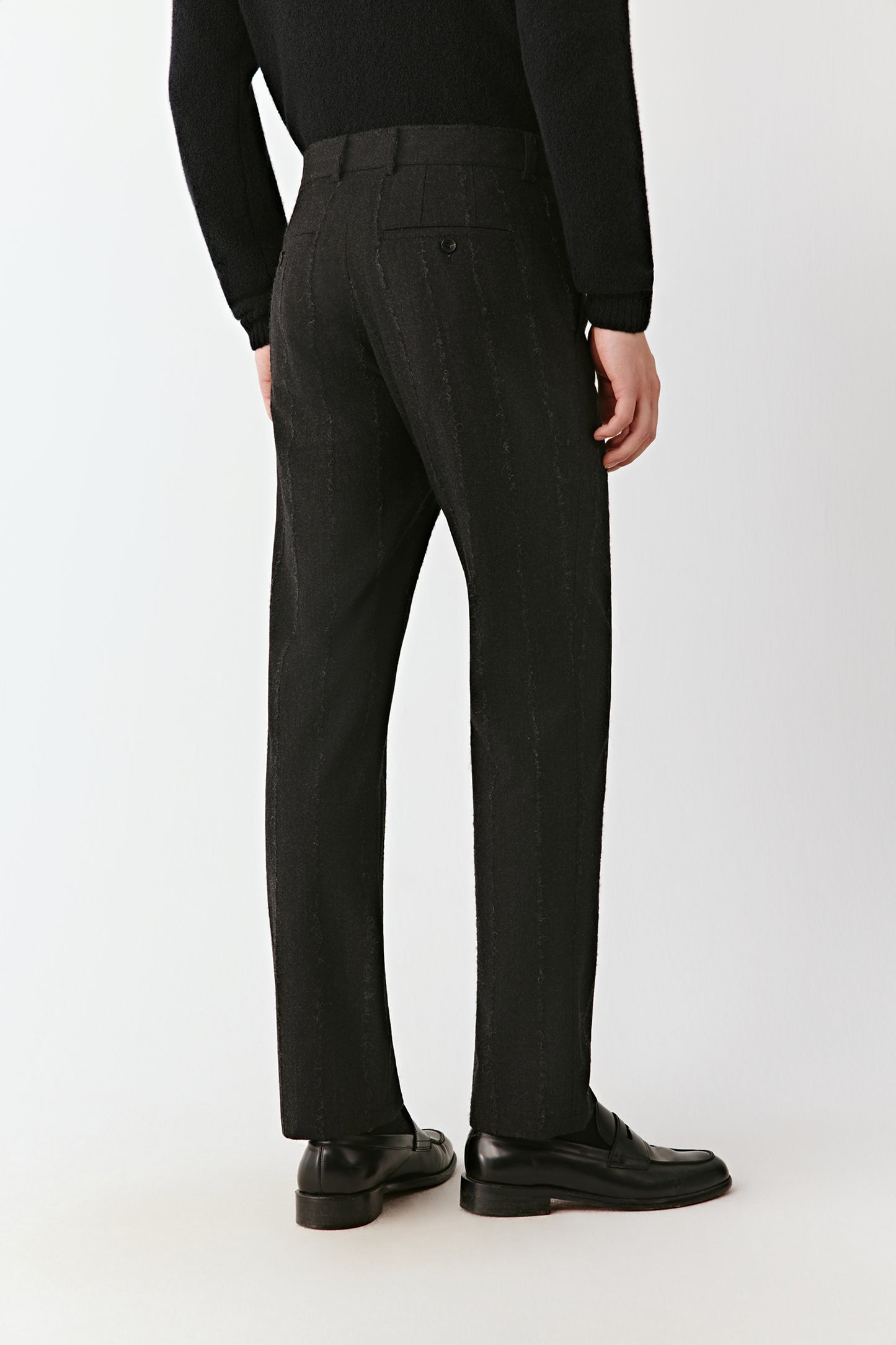 Back view of the straight-leg pinstripe trousers, highlighting a clean waistband and tailored fit.