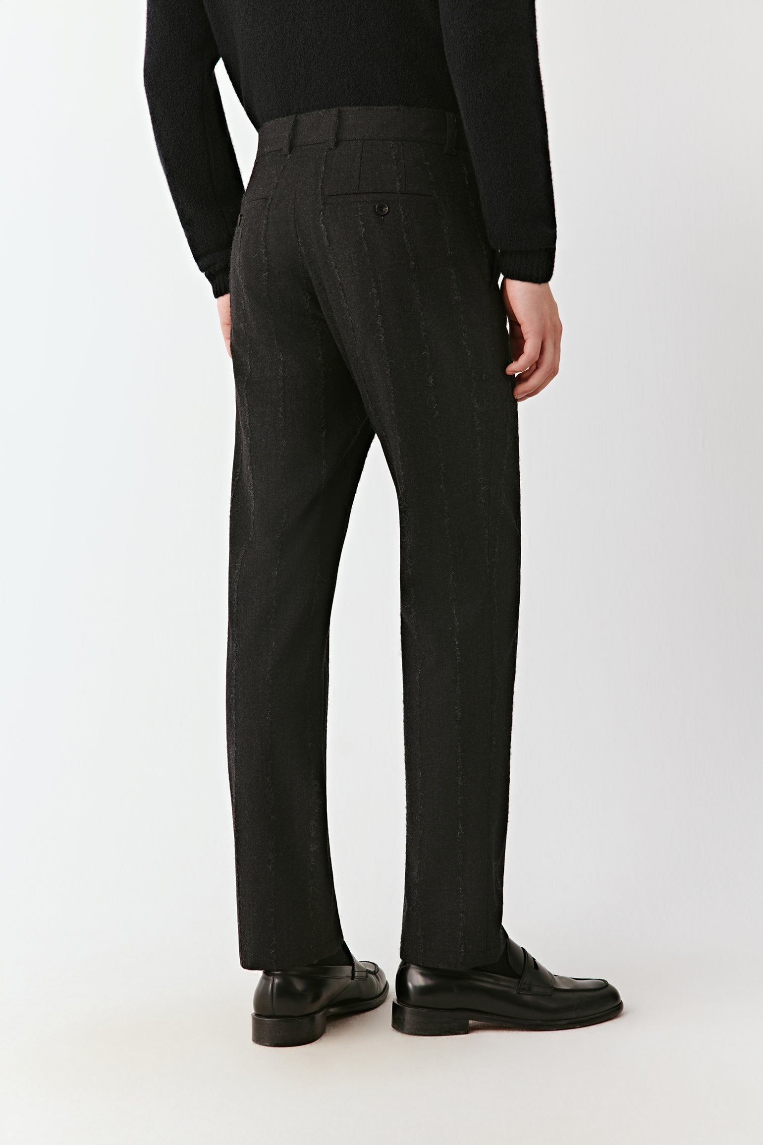 Back view of the straight-leg pinstripe trousers, highlighting a clean waistband and tailored fit.