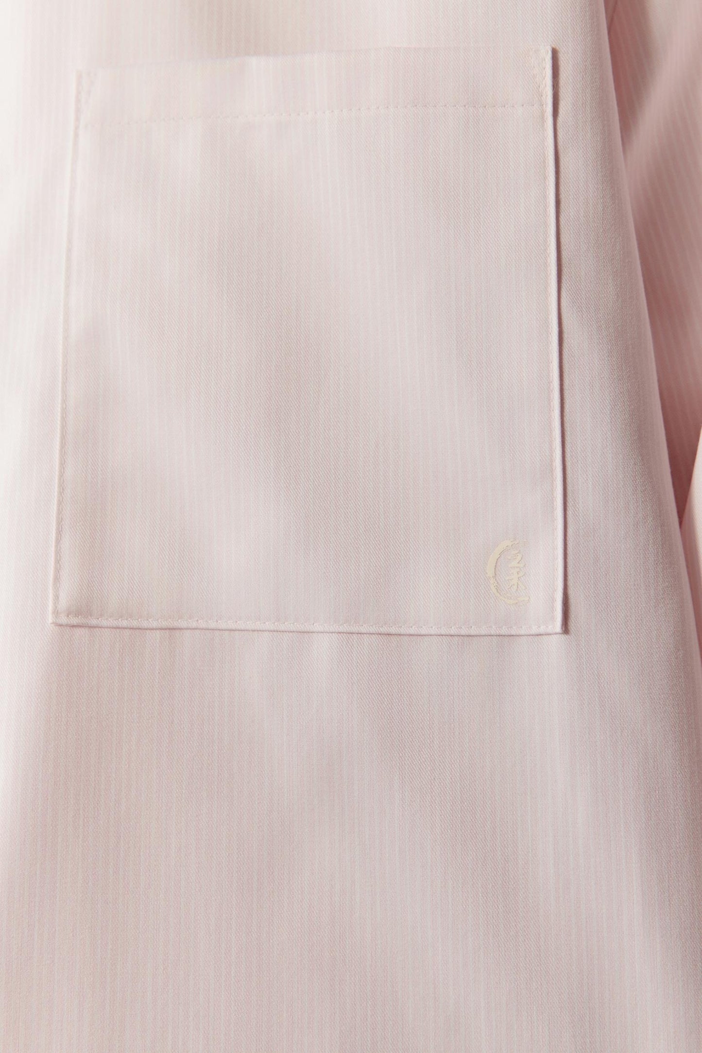 Close-up of the fabric showing the yarn-dyed striped cotton twill weave.