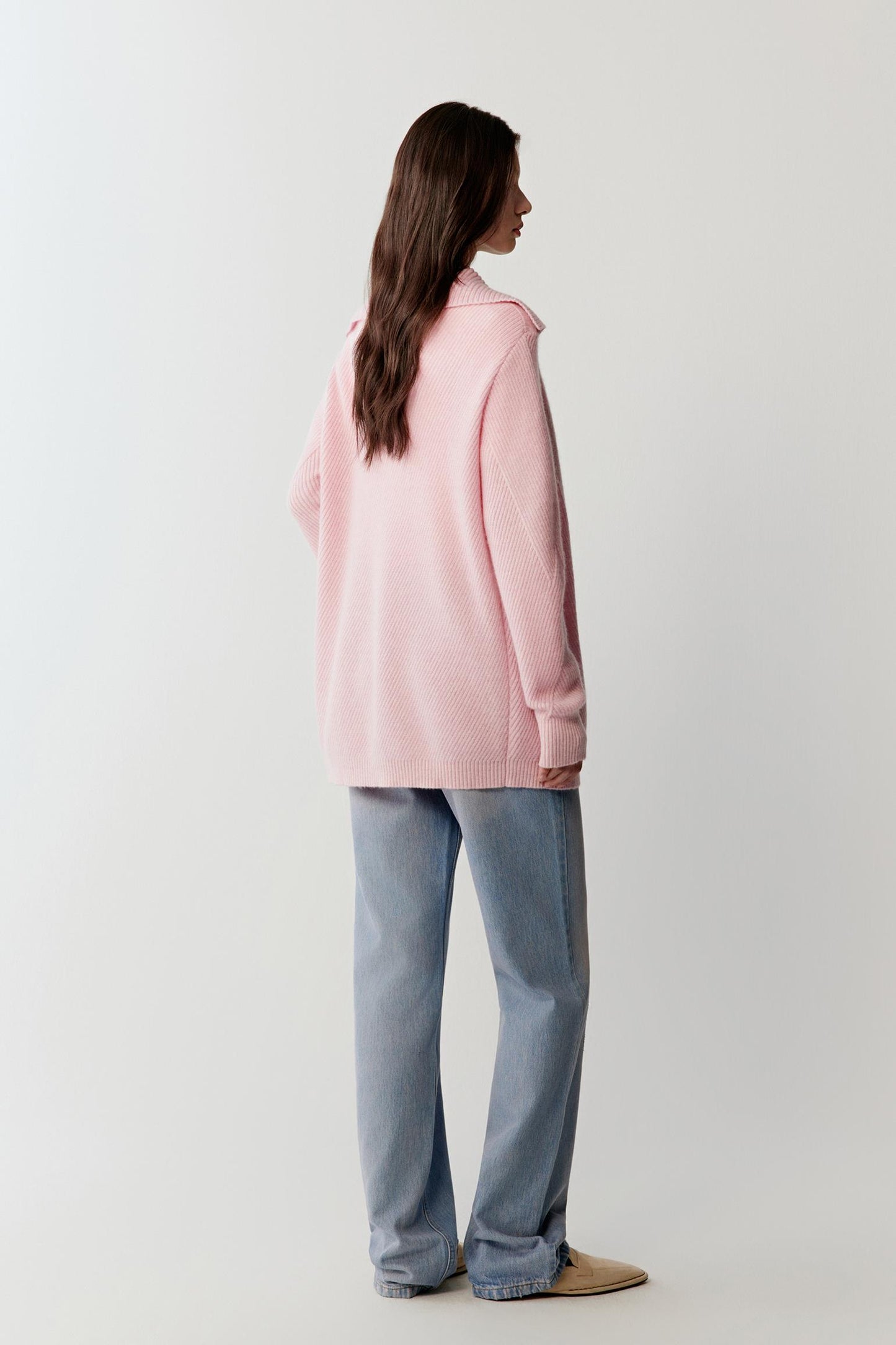 Back view highlighting the relaxed structure of the cardigan and the smooth drape of the knit fabric along the torso and sleeves.