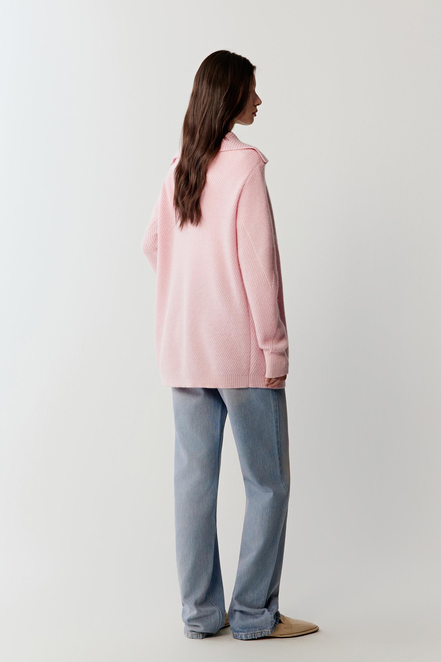 Back view highlighting the relaxed structure of the cardigan and the smooth drape of the knit fabric along the torso and sleeves.