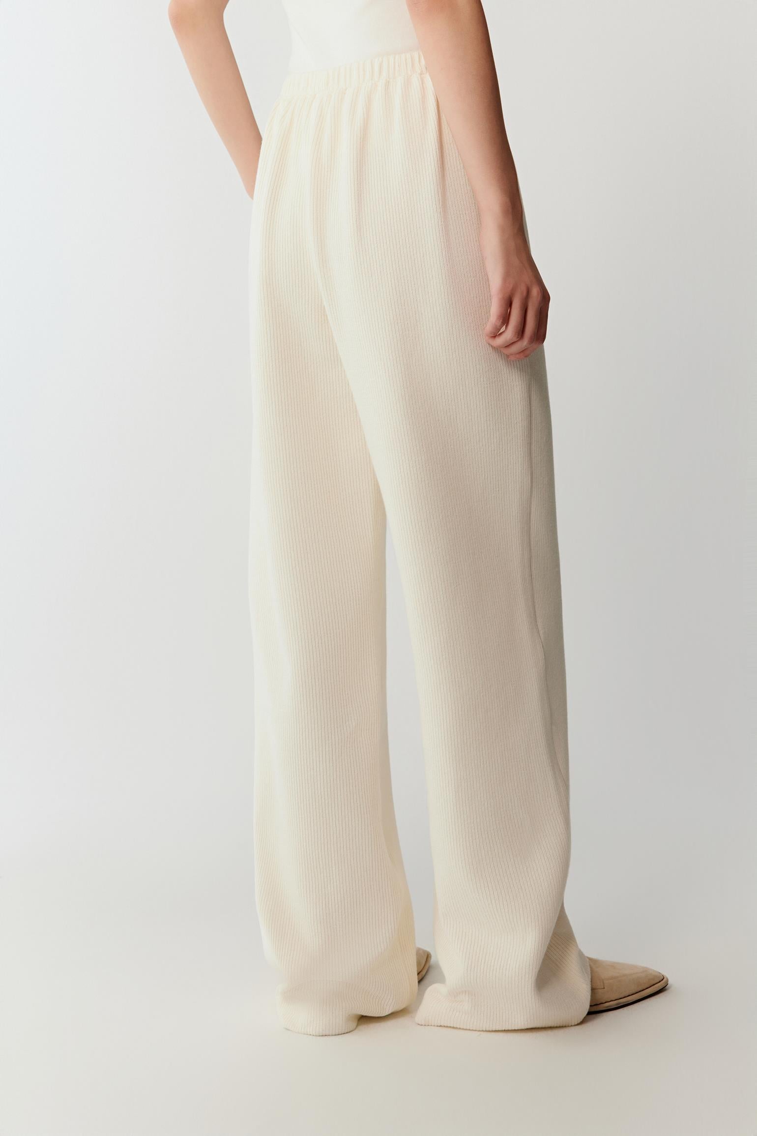 Side view emphasizing the natural stretch and softness of the cotton rib jersey as it falls smoothly from the hips to the hem.