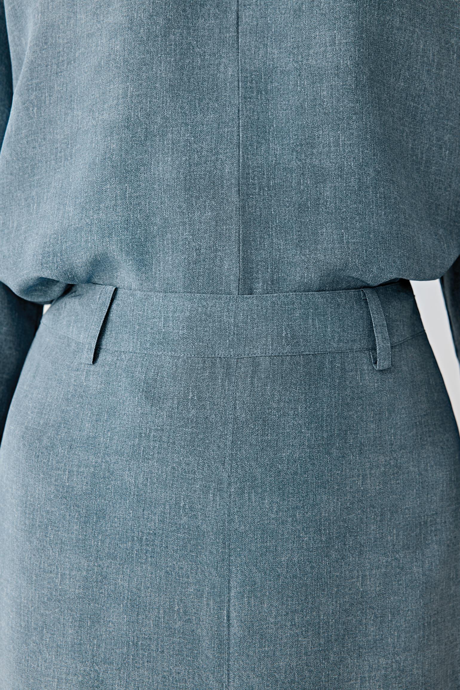 Close-up of waistband and upper skirt detailing the clean waistband, belt loops, pleated structure and subtle tonal depth of the indigo blue silk fabric