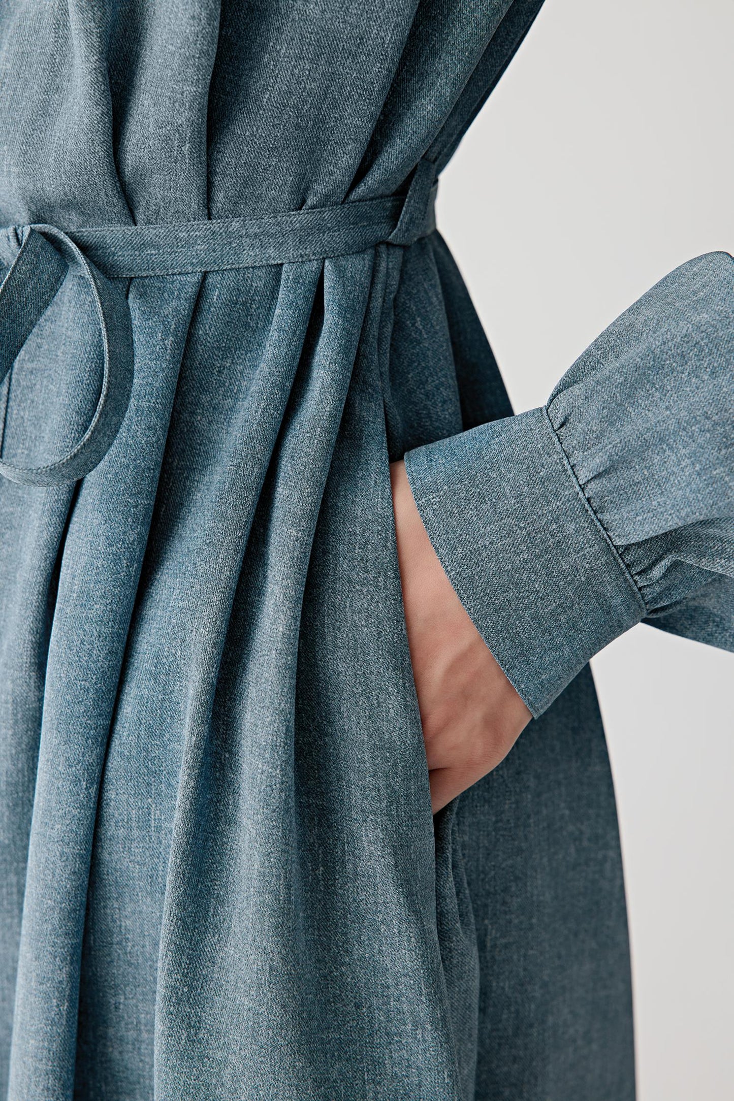Close-up of sleeve and cuff detailing the wide cuff construction, tonal buttons and visible stitching, highlighting the soft, fluid surface of the fabric