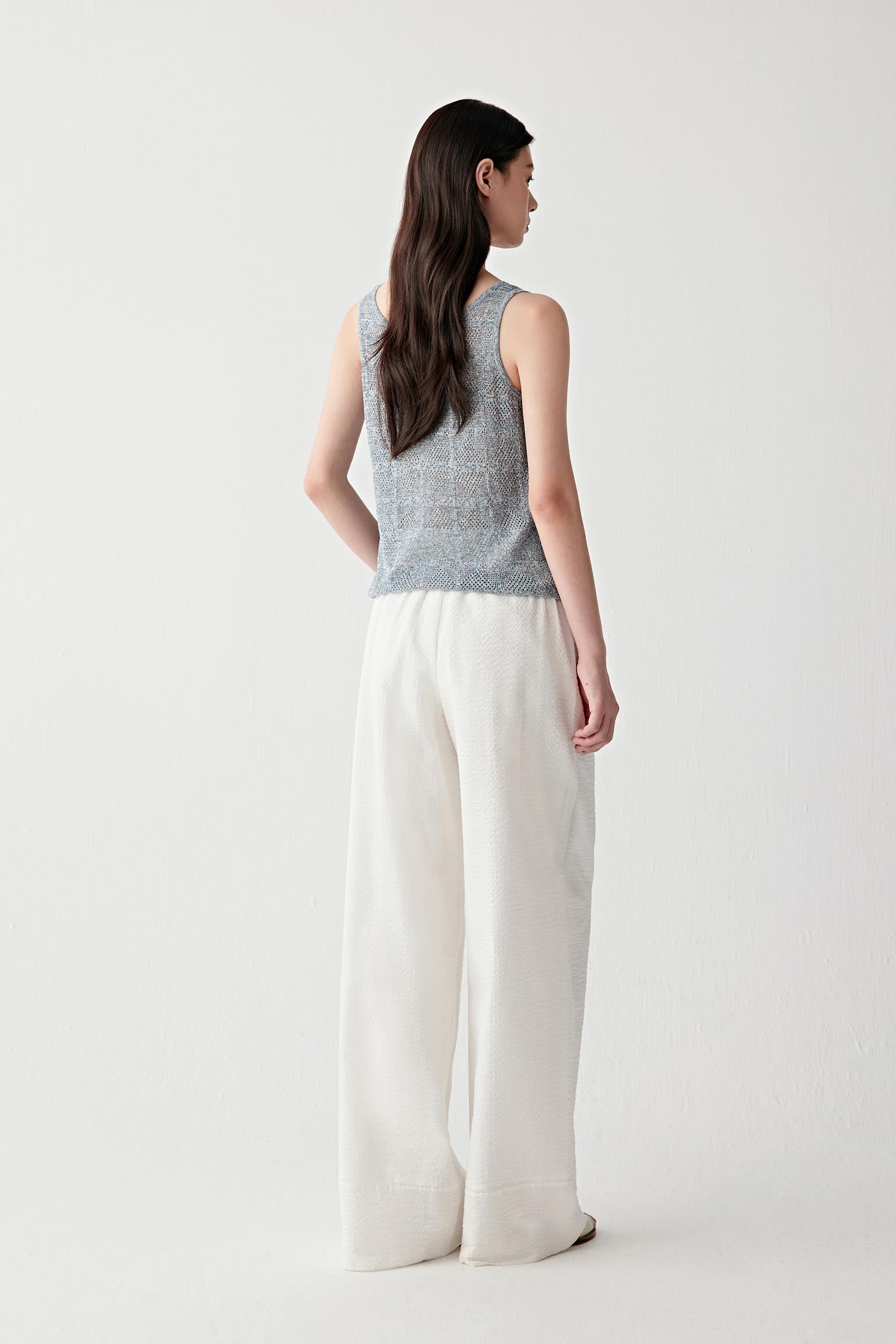 Full-length side or three-quarter view highlighting the clean silhouette, subtle transparency and naturally fluid movement of the cotton and silk knit construction