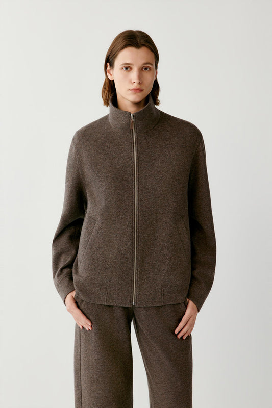 Front view highlighting the stand collar, two-way zip fastening and straight silhouette of the brown melange blouson.