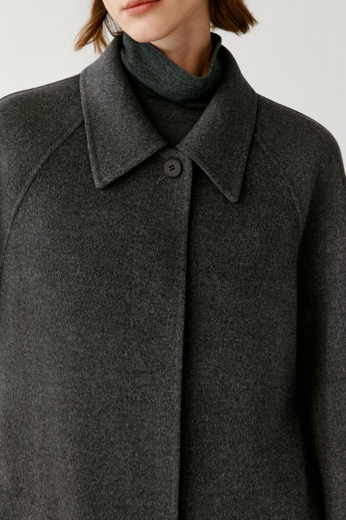 Close-up highlighting the concealed front fastening and structured double-face construction.