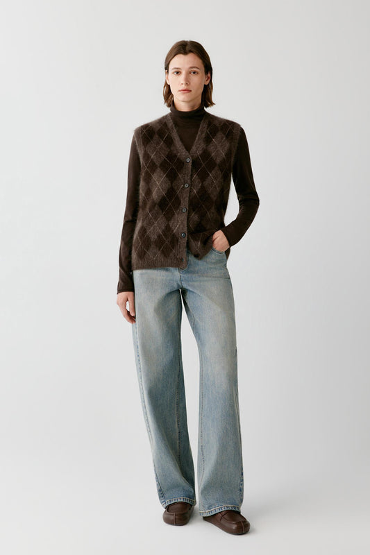 Front full-length view of a woman wearing the dark brown yak sleeveless pullover, highlighting the argyle pattern and straight silhouette.