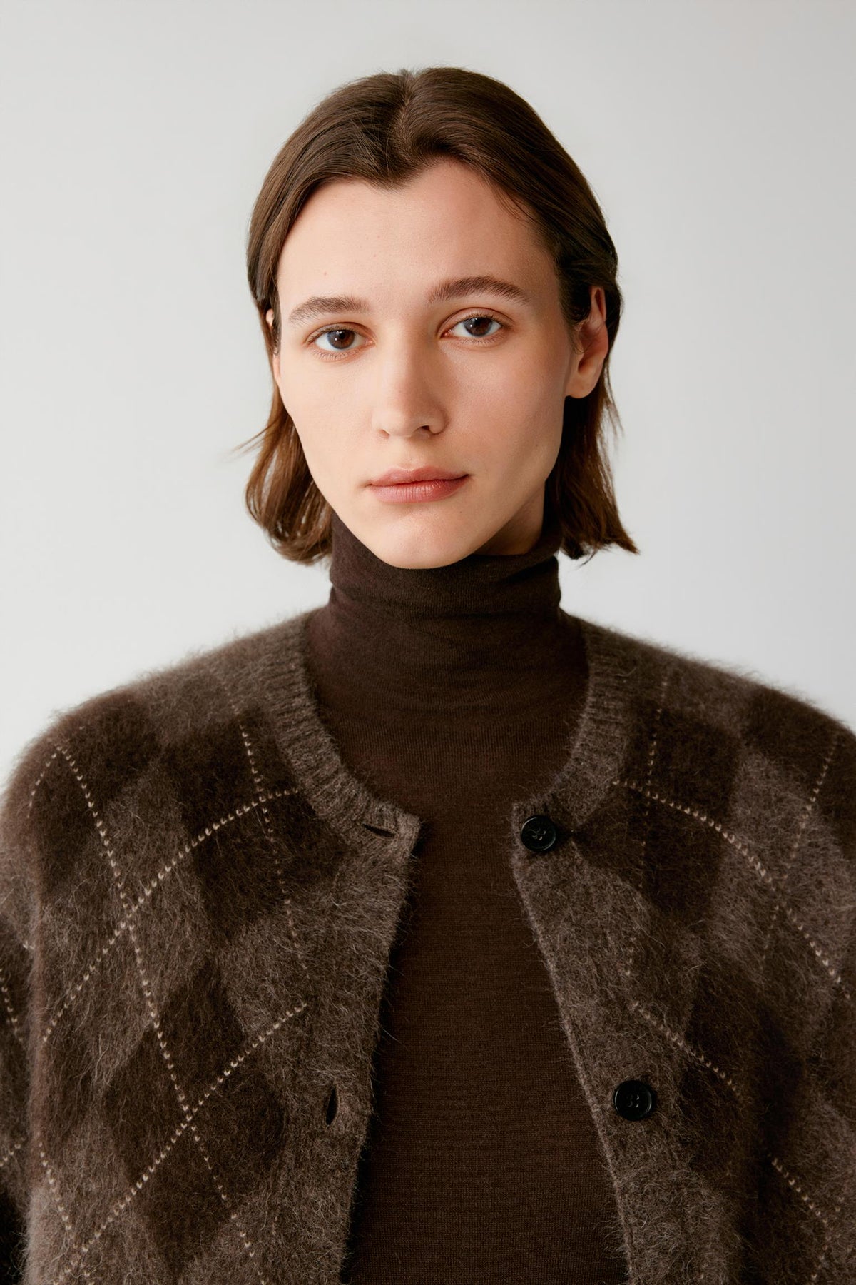 Front close-up highlighting the crew neckline, button-front fastening and brushed yak knit texture.
