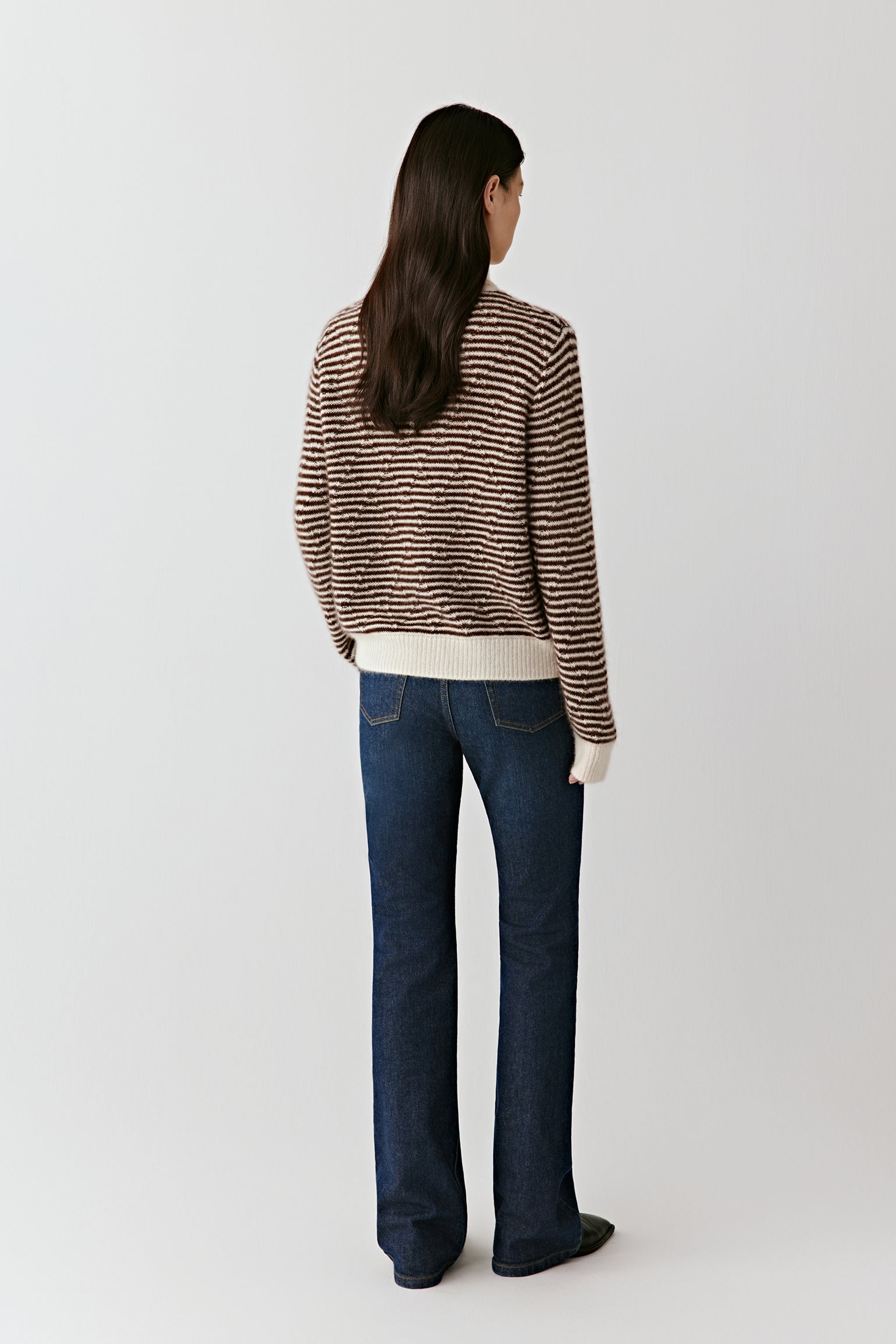 Side or back angled view of the striped cardigan, highlighting the drape and striped pattern across the back.