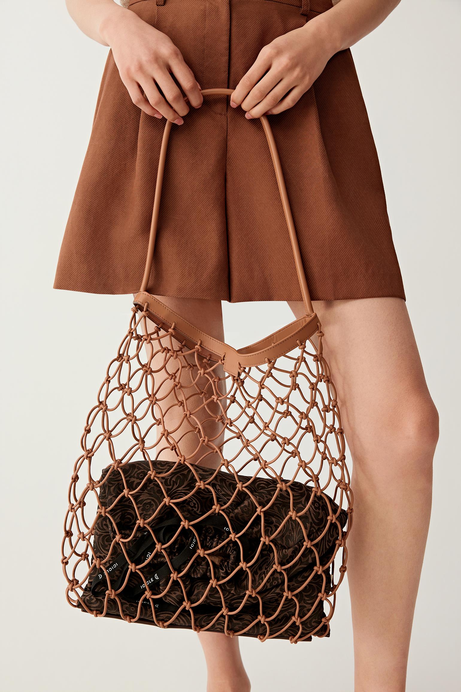 Three-quarter view showing the net bag and inner pouch, emphasizing the volume and transparency effect.