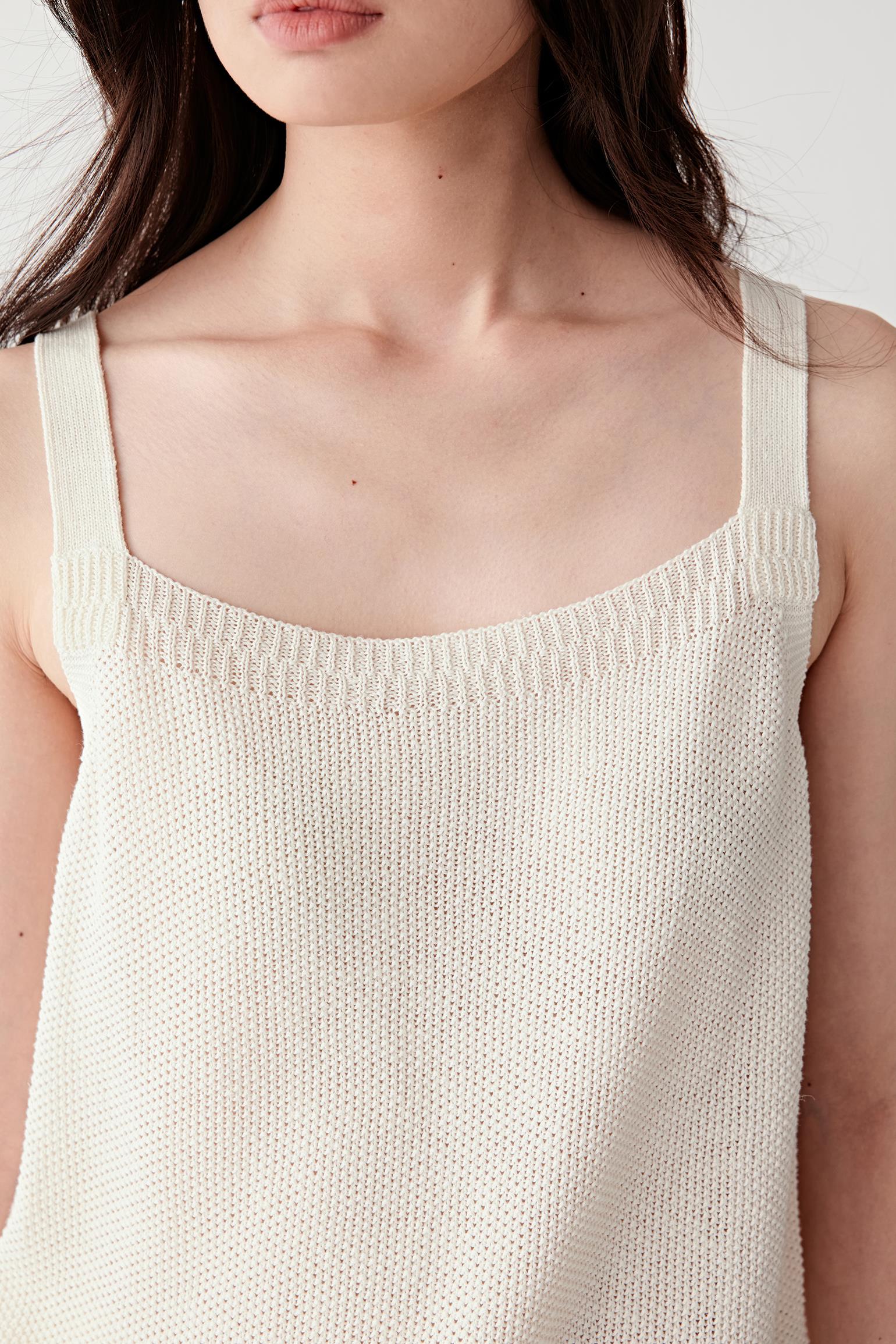 Close-up of neckline and chest showing fine ribbed knit, soft sheen and smooth finishing