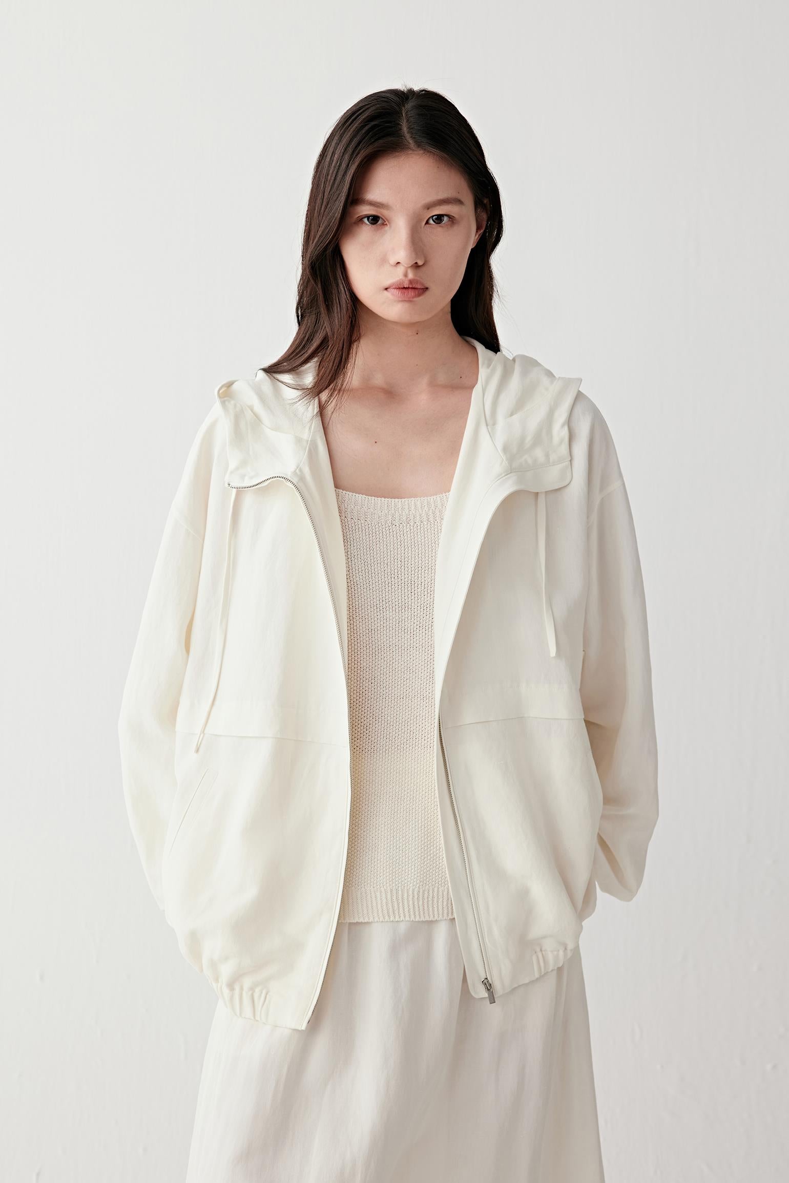 Three-quarter view highlighting sleeve volume, gathered hem and overall relaxed proportions