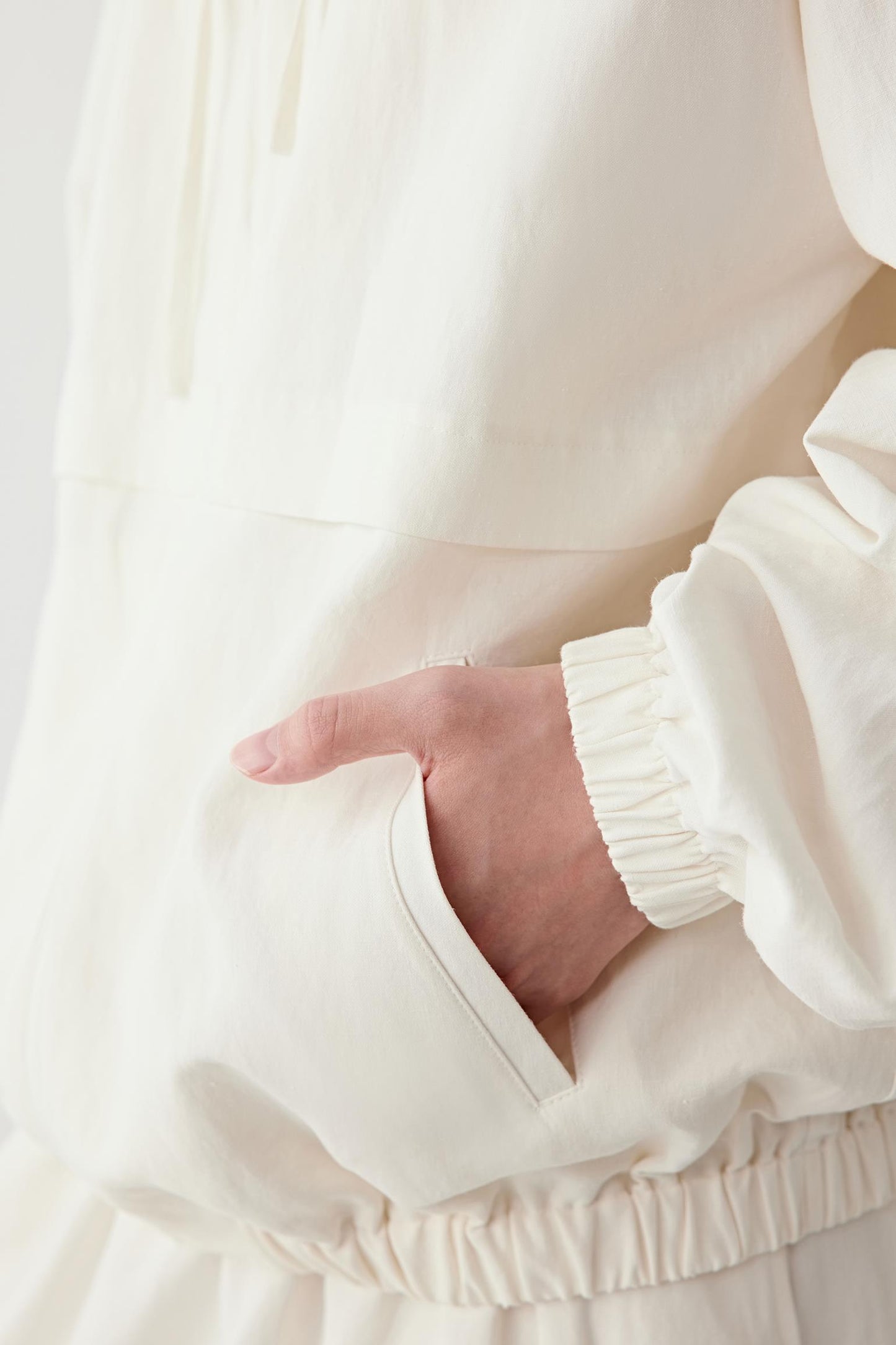 Close-up of the sleeve and cuff, showing the elasticated cuff construction, stitching details and the natural texture of the silk and linen blend