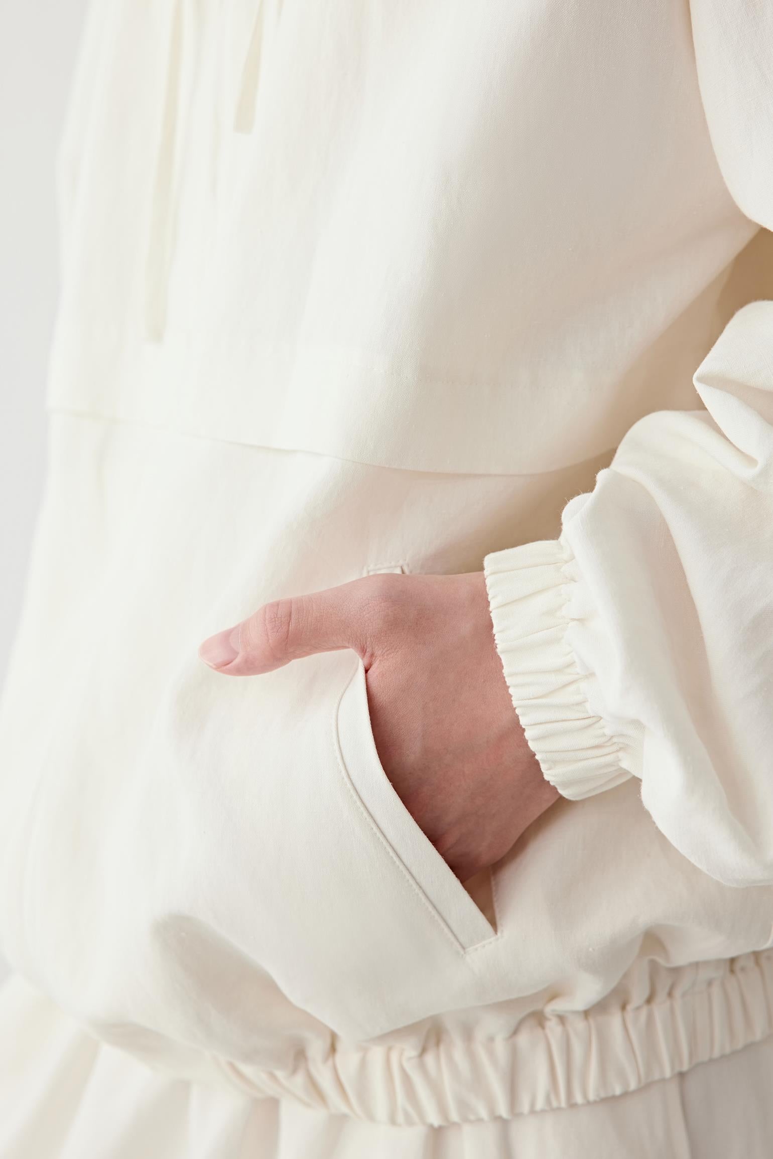 Close-up of the sleeve and cuff, showing the elasticated cuff construction, stitching details and the natural texture of the silk and linen blend