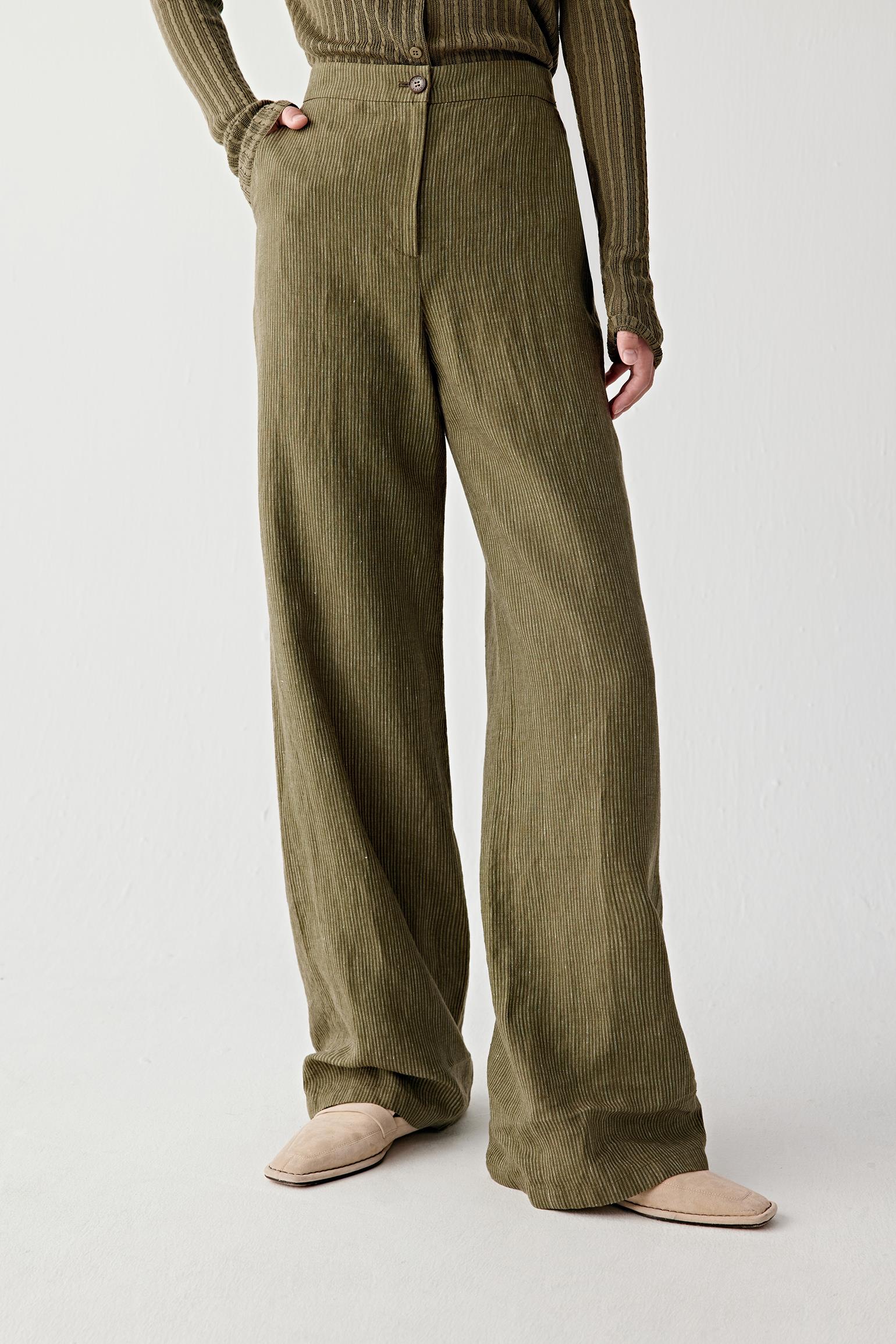 Mid-length front view focusing on the trousers, showing straight fall from waist to hem and subtle vertical texture of yarn-dyed linen