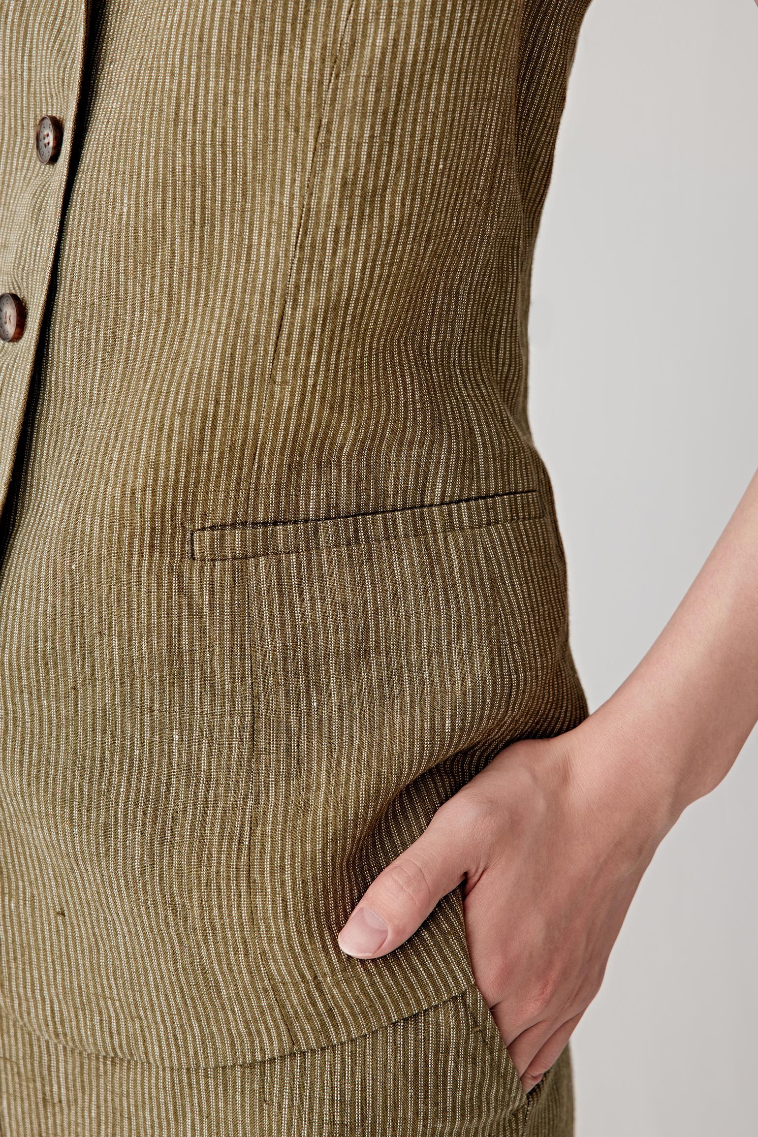 Close-up of the side and pocket area, highlighting the discreet welt pocket construction, seam lines and the natural grain of the linen fabric with its matte finish and subtle variation in weave