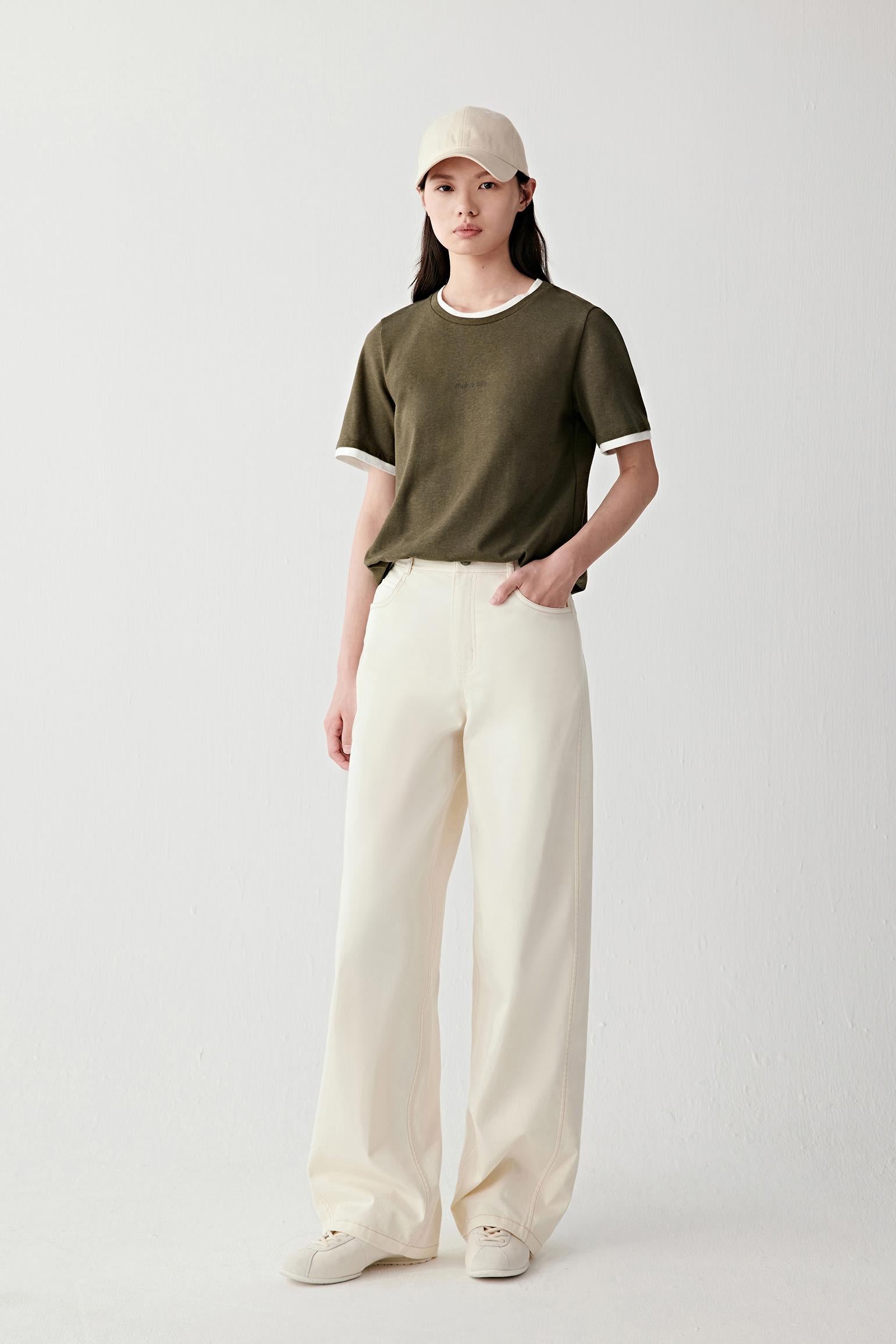 Full-length front view emphasizing the balanced proportions, soft structure and matte surface of the fabric against light trousers