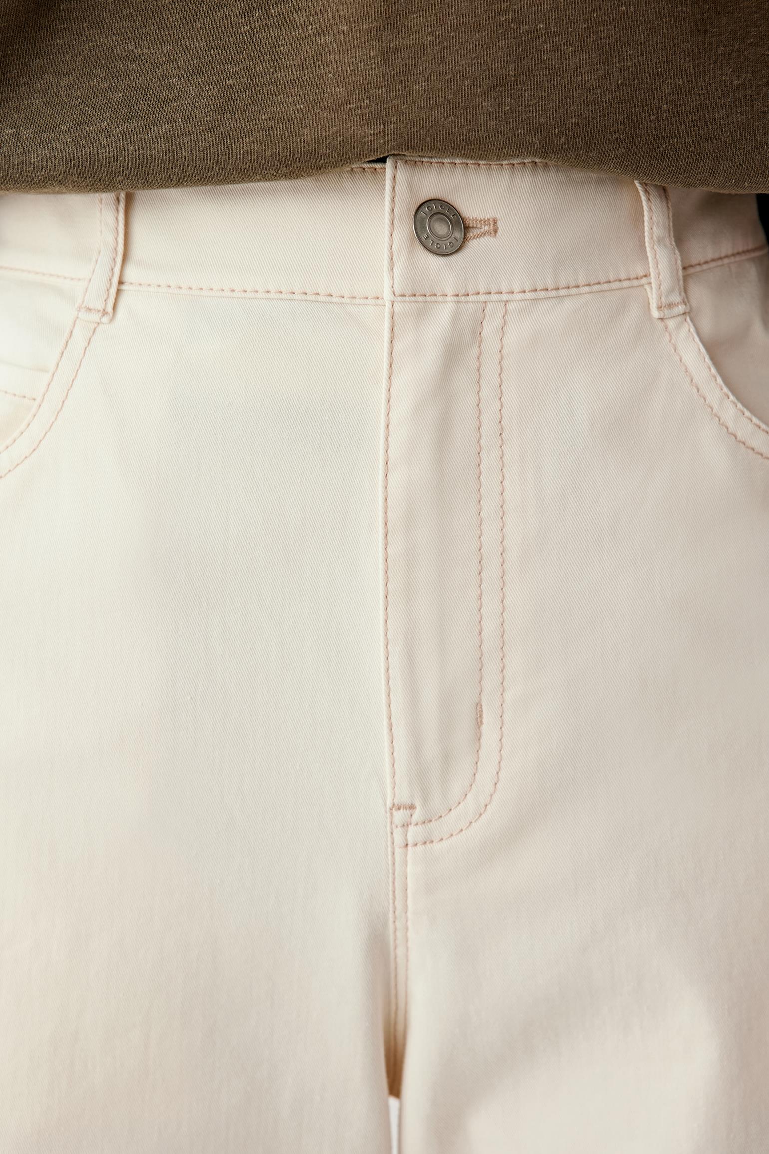 Close-up of waistband and front pleat showing stitching, pocket construction and twill texture