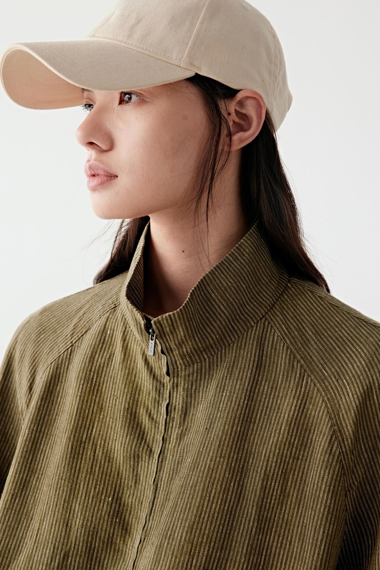 Close-up portrait showing collar, neckline and texture of yarn-dyed linen