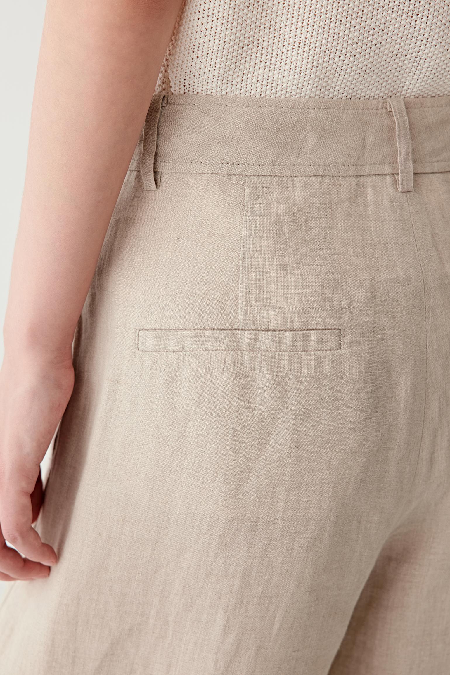 Close-up of side or back pocket showing the lightly textured surface, visible stitching and soft matte finish of the plain-woven linen fabric