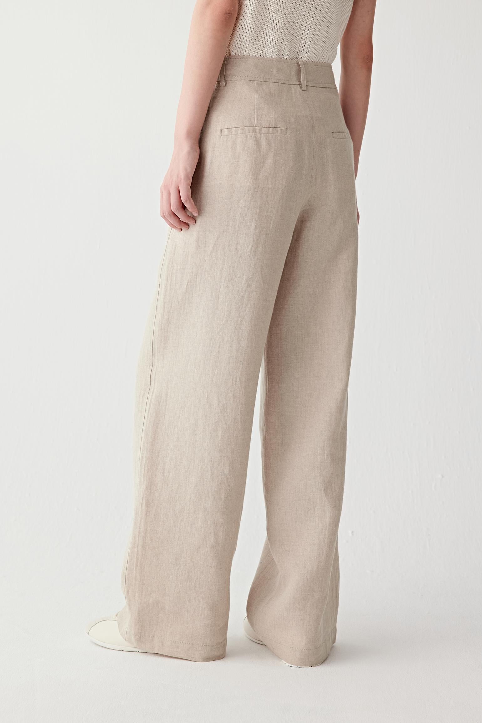 Full-length side or back view showing the elongated line and soft drape of the trousers, with the lightweight woven texture visible throughout the silhouette