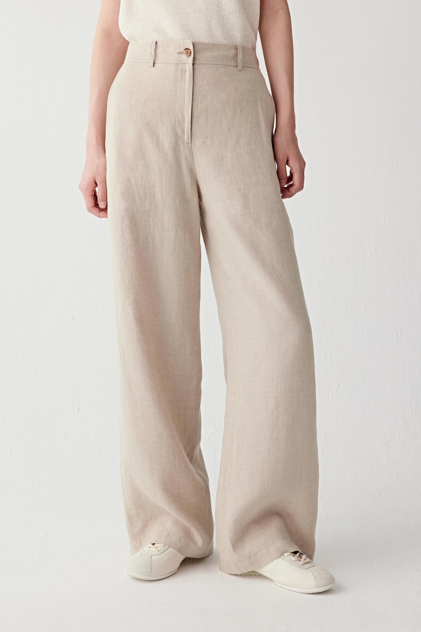 Front view focusing on the straight wide-leg silhouette and high waist construction, emphasizing the fluid movement and airy structure of the linen fabric
