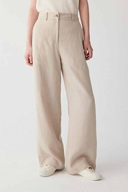 Front view focusing on the straight wide-leg silhouette and high waist construction, emphasizing the fluid movement and airy structure of the linen fabric