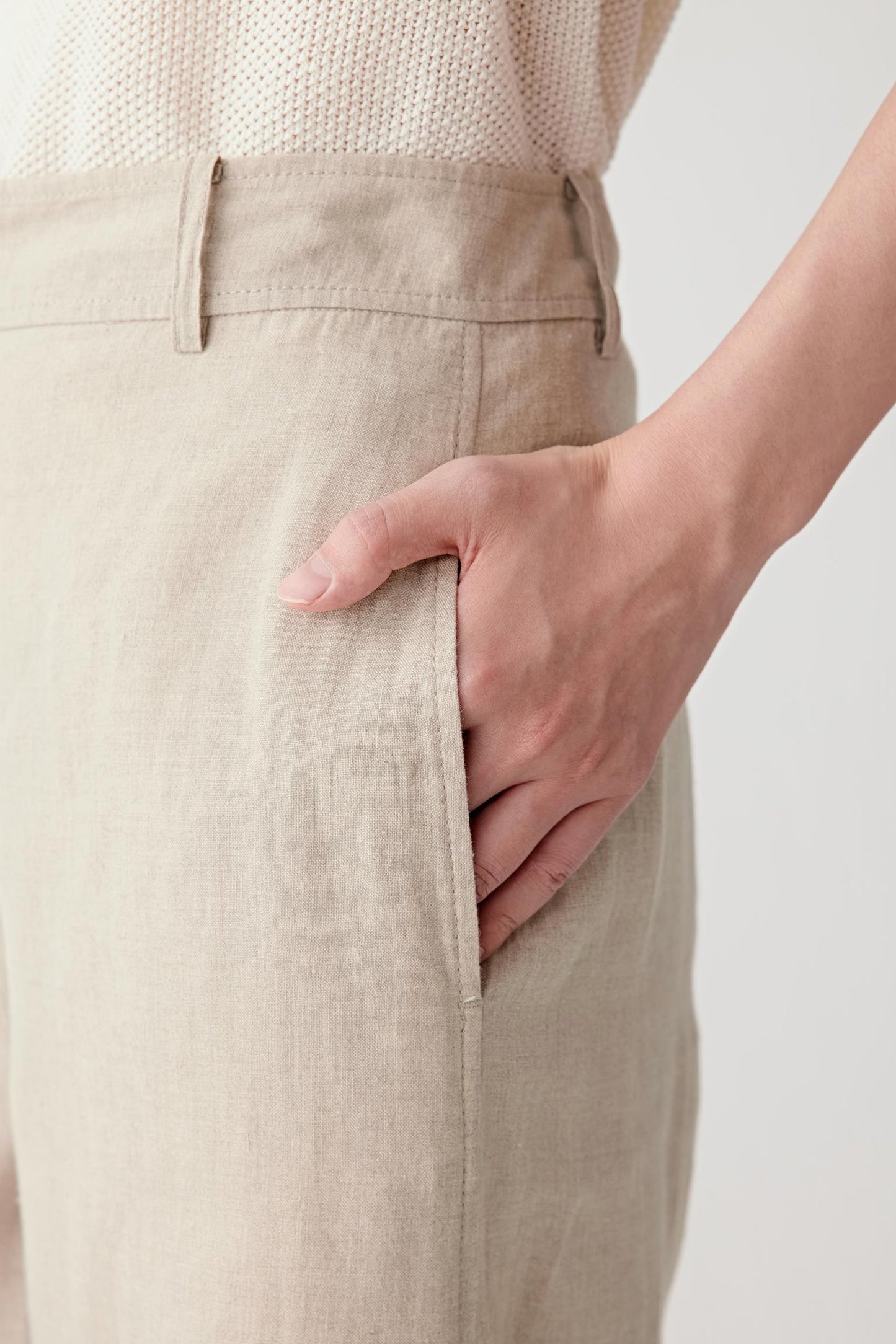 Close-up of pocket showing the lightly textured surface, visible stitching and soft matte finish of the plain-woven linen fabric