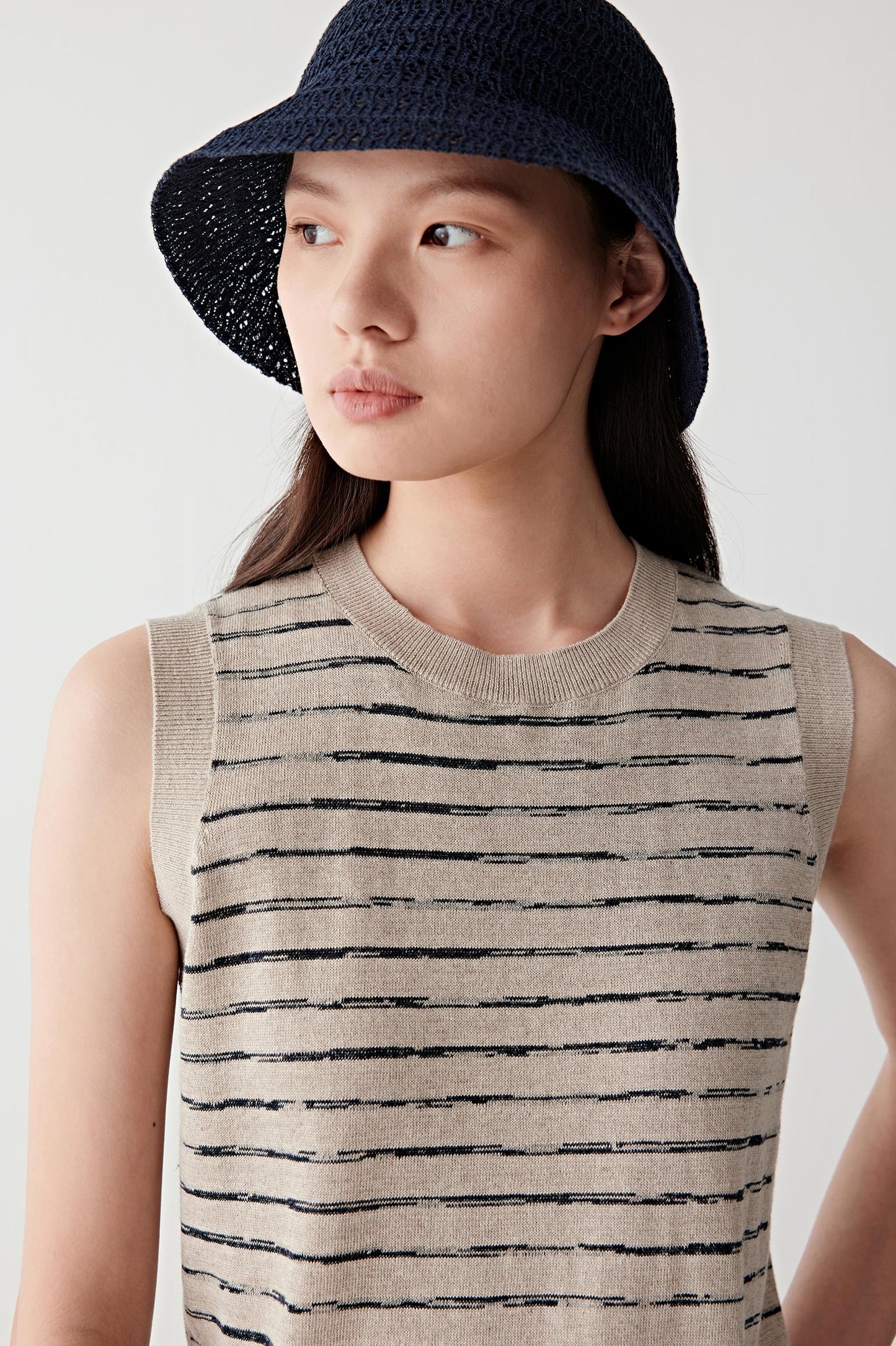 Close-up of neckline and upper chest showing fine knit texture and stripe detail