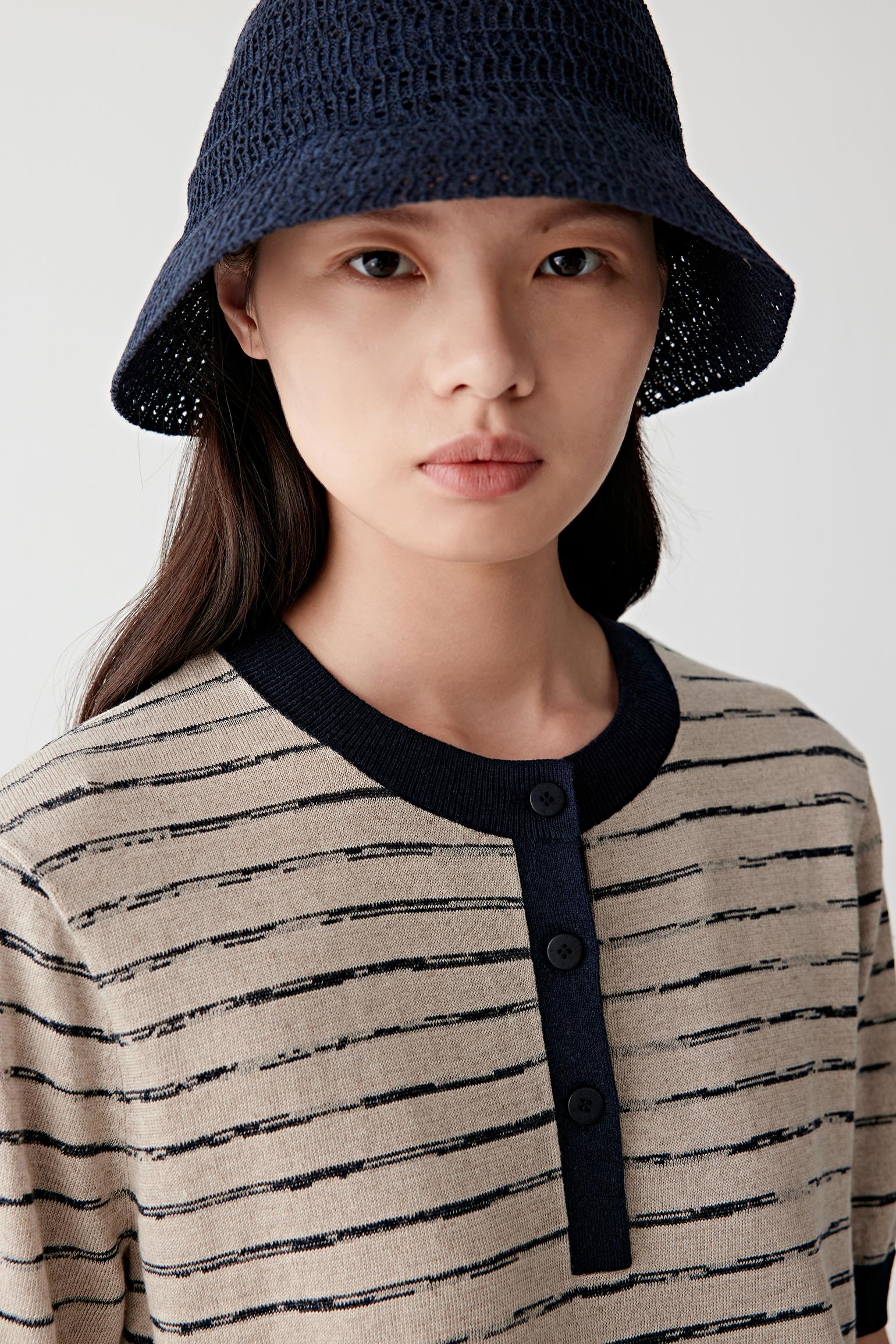 Close-up portrait highlighting neckline, stripe alignment and knit texture