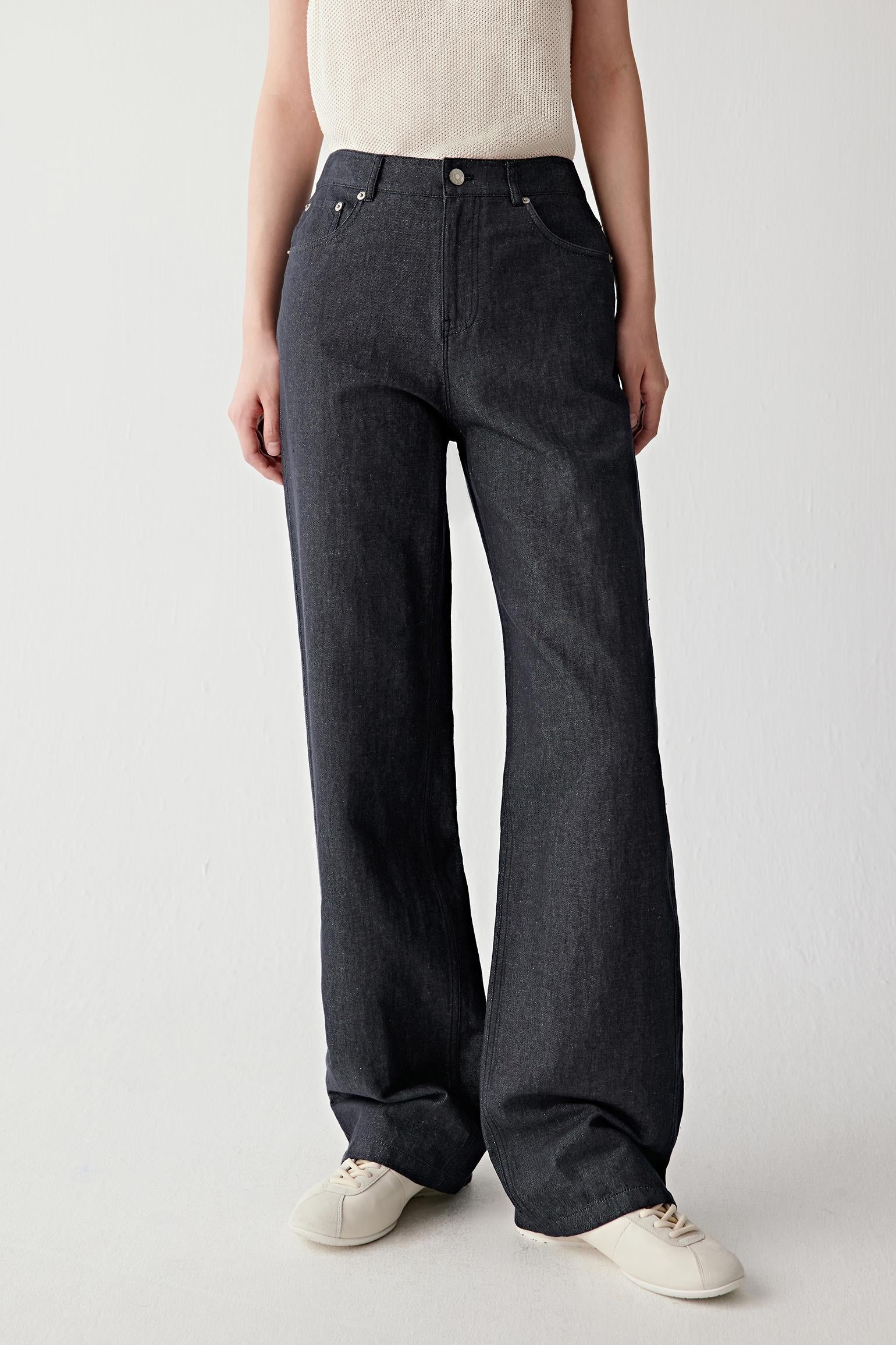 Mid-length front view focusing on the trousers from waist to hem, emphasizing the straight-leg cut, balanced volume through the leg and the slightly textured surface characteristic of hemp and cotton twill
