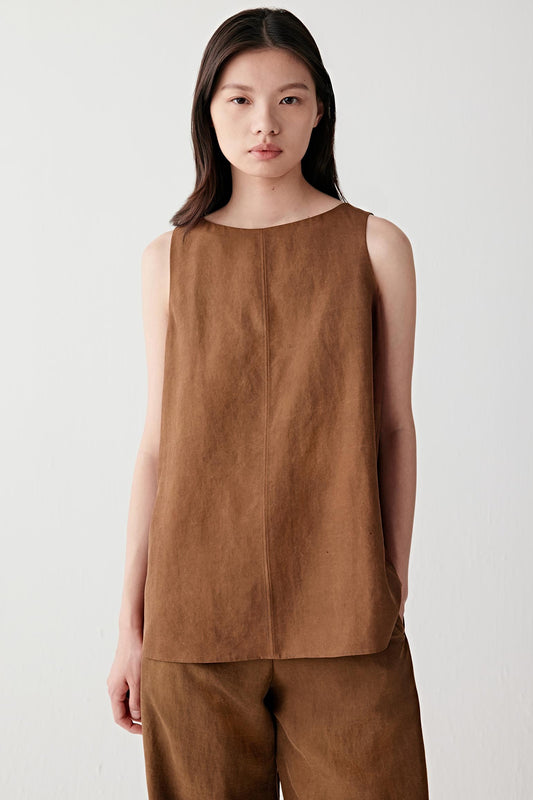 Front view of a woman wearing a warm brown Gambiered Canton Gauze sleeveless top, highlighting the compact woven structure, lightly textured matte surface and softly straight silhouette