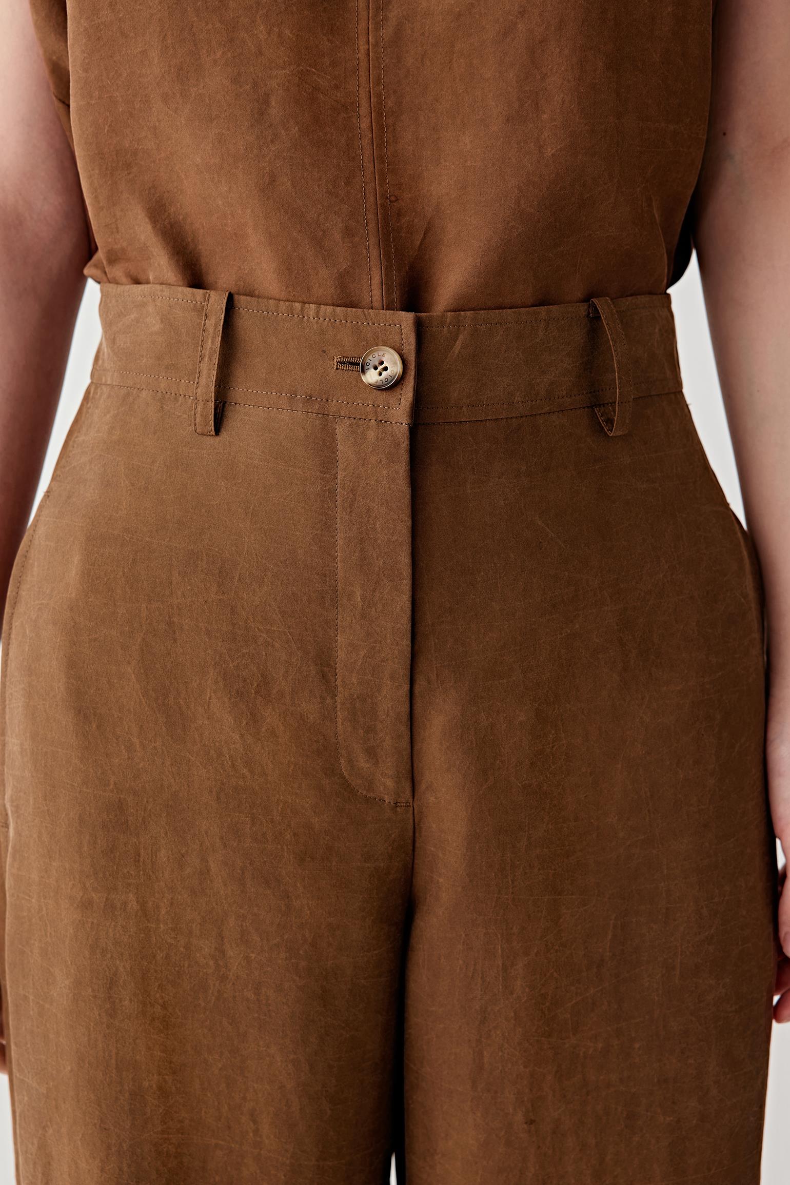 Close-up of waistband and front fastening detailing the fitted waistband, concealed fastening and softly textured woven surface characteristic of Gambiered Canton Gauze