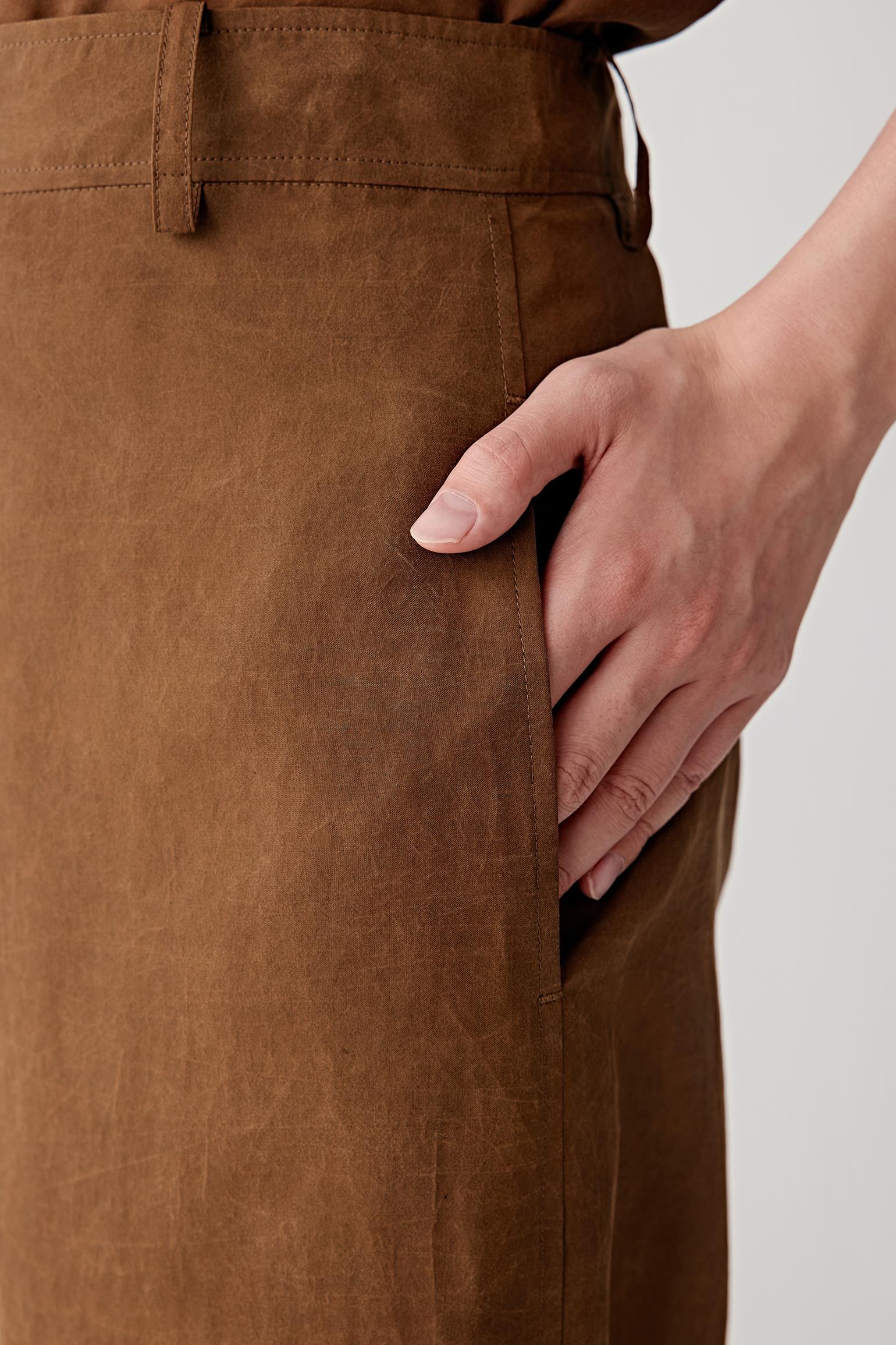 Close-up of waistband and front fastening detailing the fitted waistband, concealed fastening and softly textured woven surface characteristic of Gambiered Canton Gauze
