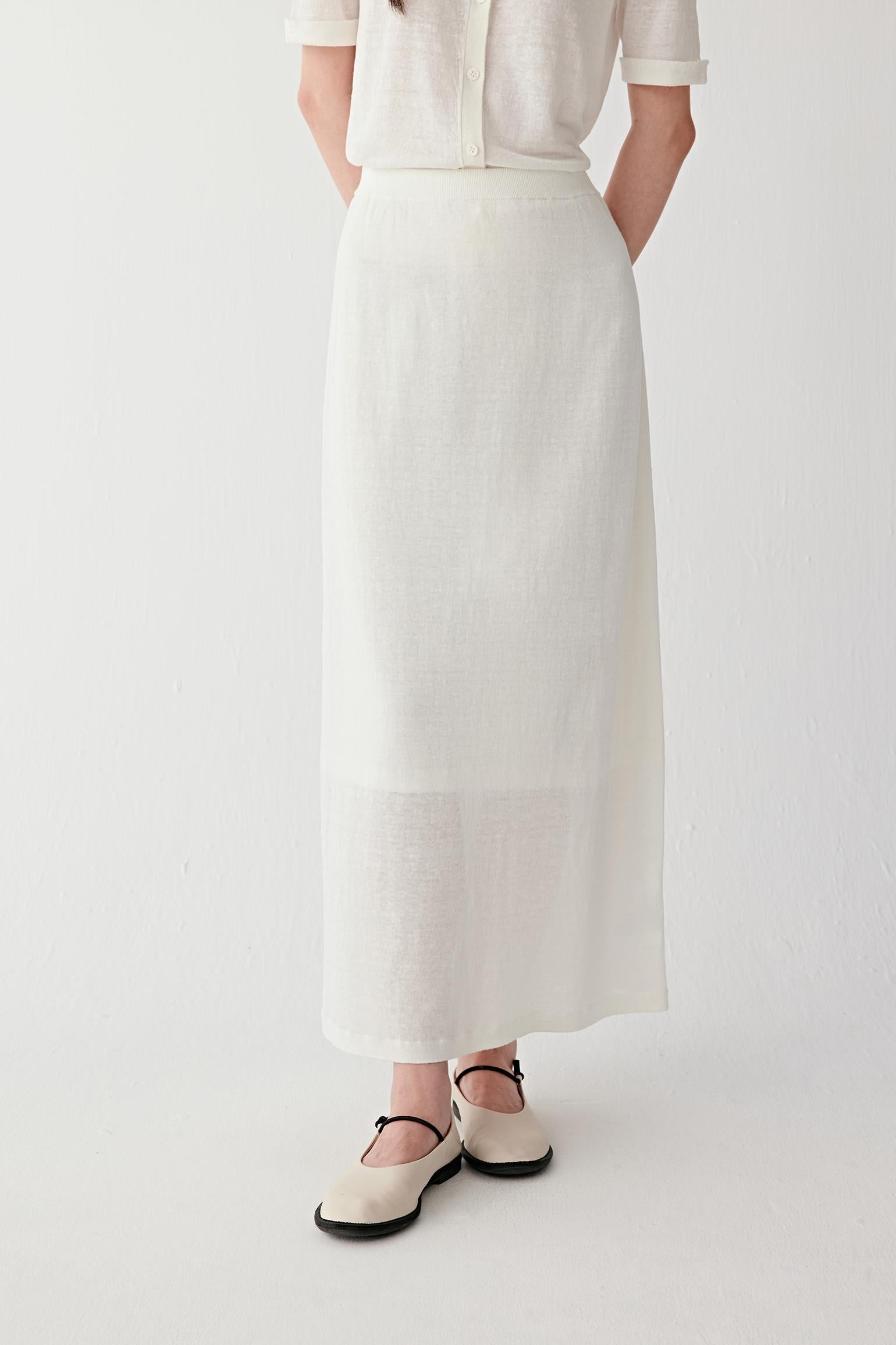 Front view focusing on the lower silhouette and hemline, emphasizing the elongated straight cut, soft movement and lightweight woven structure of the linen and nylon blend