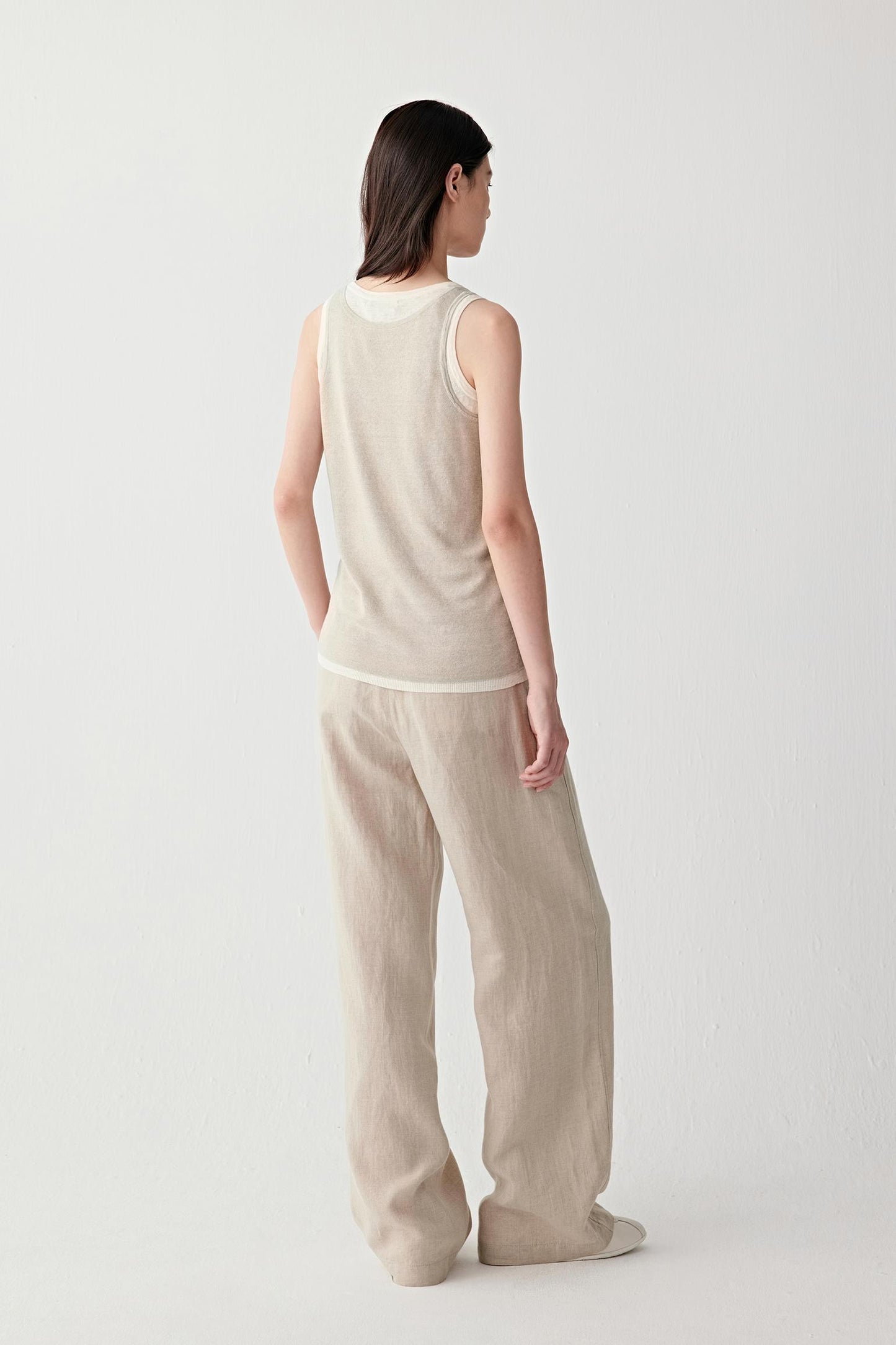 Side or back view highlighting the straight silhouette and airy openwork texture through the body