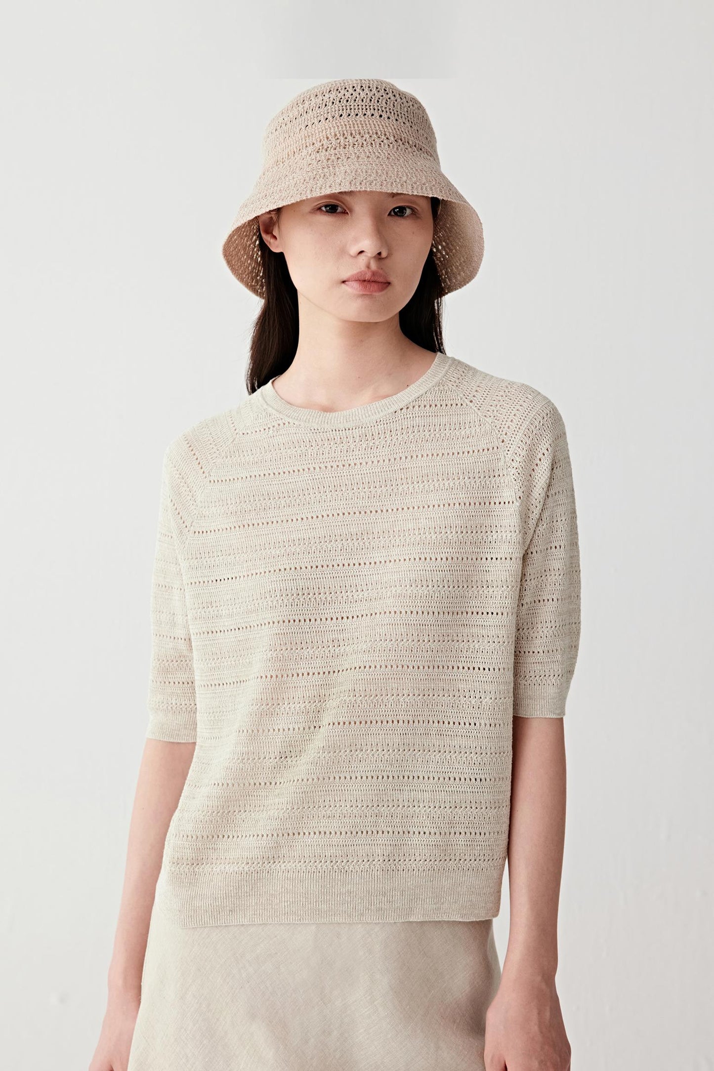 Front or three-quarter view emphasizing the relaxed silhouette and horizontal stitch pattern, showing the airy construction of the knit
