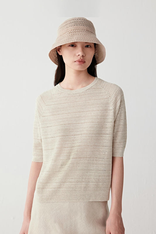 Front or three-quarter view emphasizing the relaxed silhouette and horizontal stitch pattern, showing the airy construction of the knit