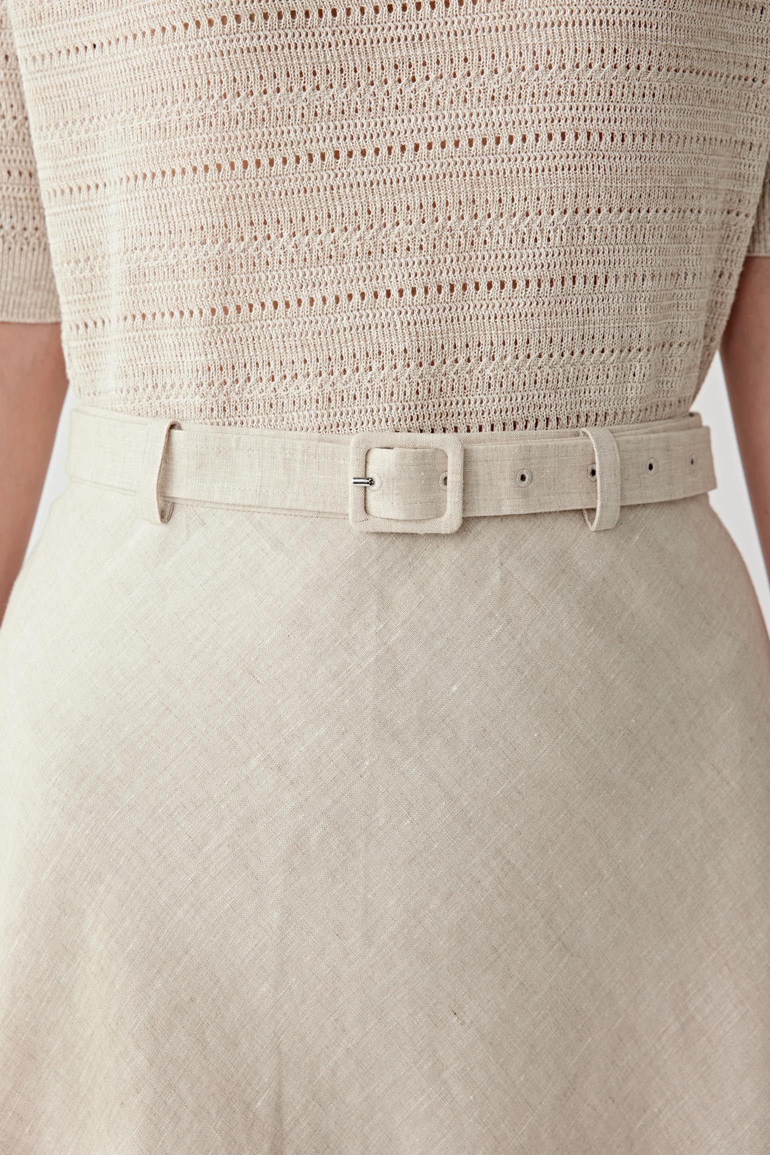Close-up of lower skirt and hem showing the lightly textured matte surface, fluid drape and softly flared construction of the linen fabric