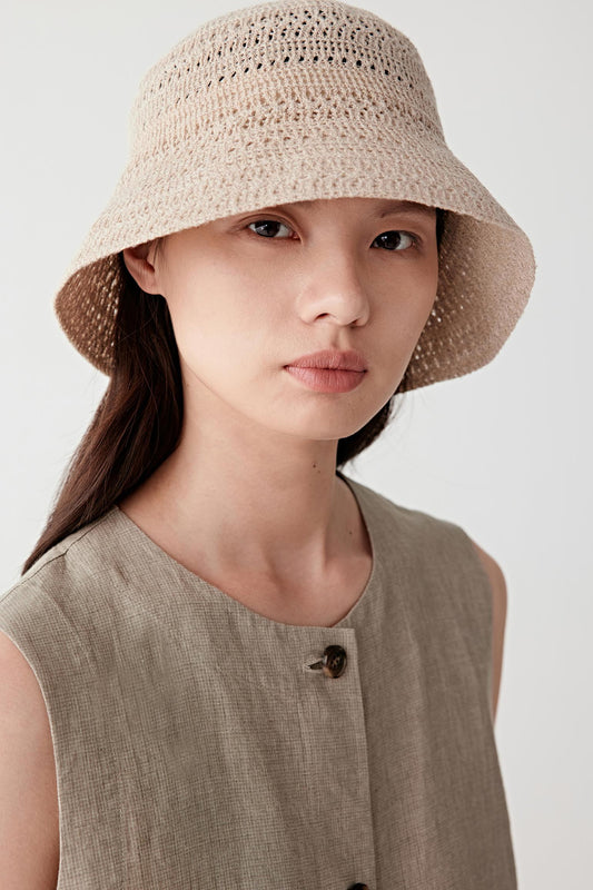 Three-quarter front view showing the hat at a slight angle, emphasizing how the crown sits close to the head, the even distribution of the knit pattern and the natural balance between structure and flexibility