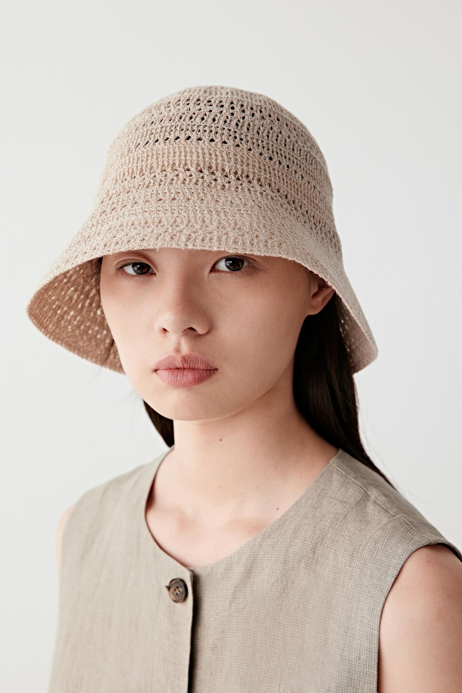 Rear three-quarter view showing the back of the hat, with a continuous knit construction, rounded crown and clean, uninterrupted brim line encircling the head