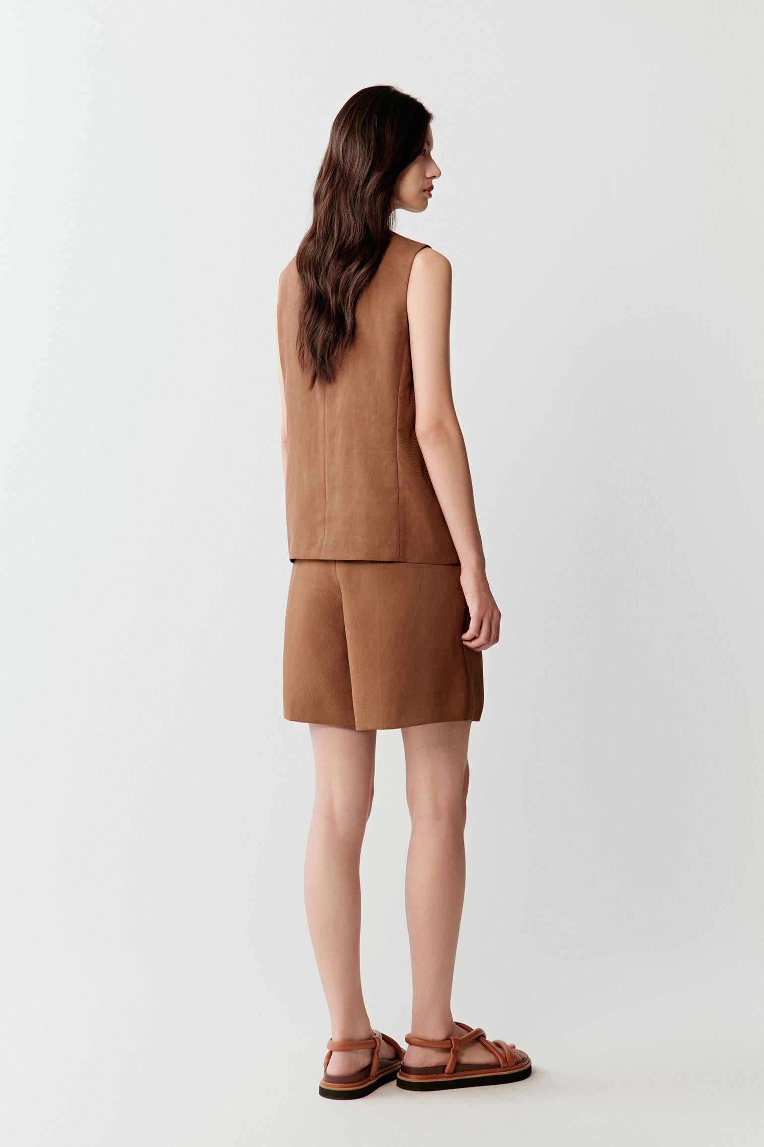 Full-length side or three-quarter view highlighting the straight sleeveless cut, fluid movement and softly structured drape of the compact woven Gambiered Canton Gauze fabric