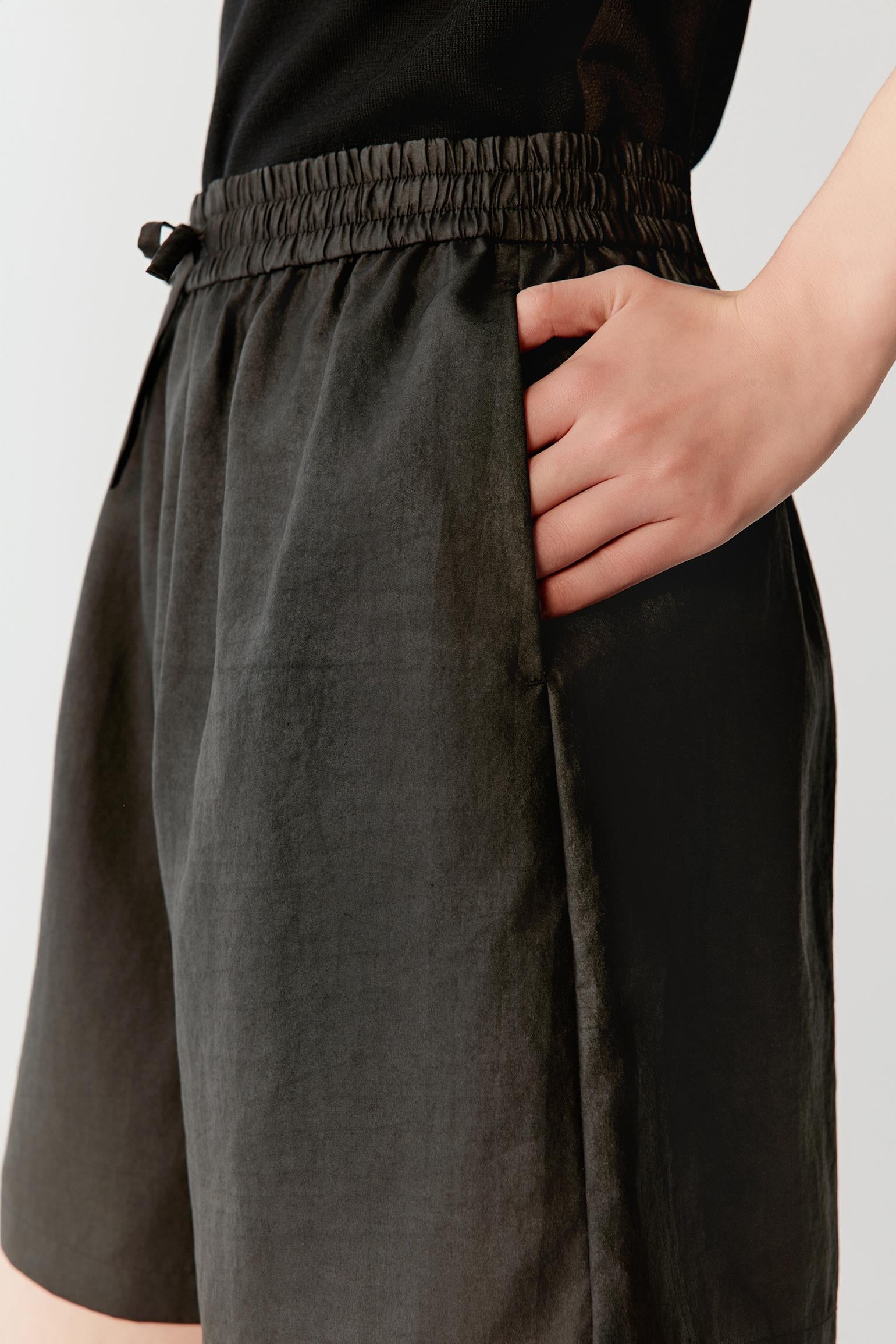 Close-up of waistband and drawstring detailing the gathered construction, matte texture and tonal depth characteristic of Gambiered Canton Gauze