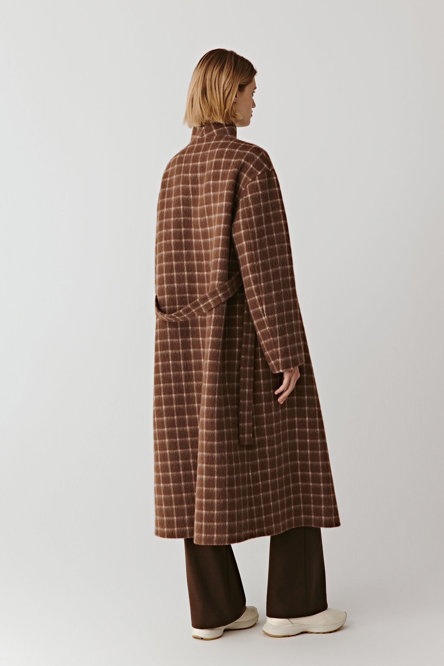 Back view of the double-faced checked wool coat, showing the all-over check pattern and straight cut.