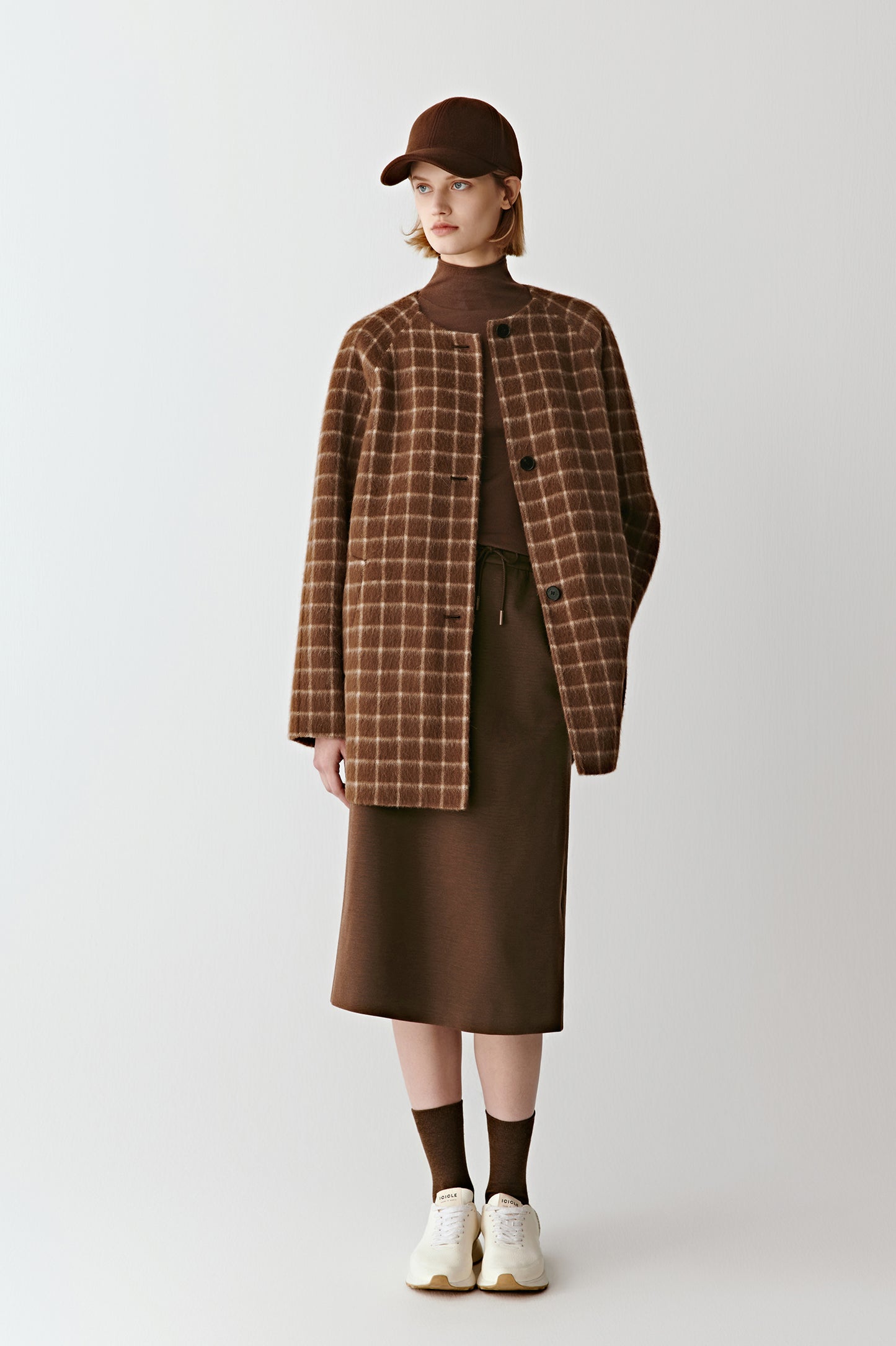 Full-length front view of a short double-faced checked wool coat in brown tones, featuring a collarless neckline and clean silhouette.