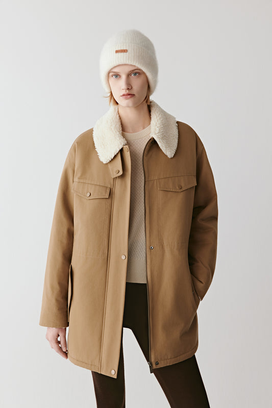 Three-quarter view showing the cotton twill parka’s shearling-effect collar, flap pockets, and relaxed fit.