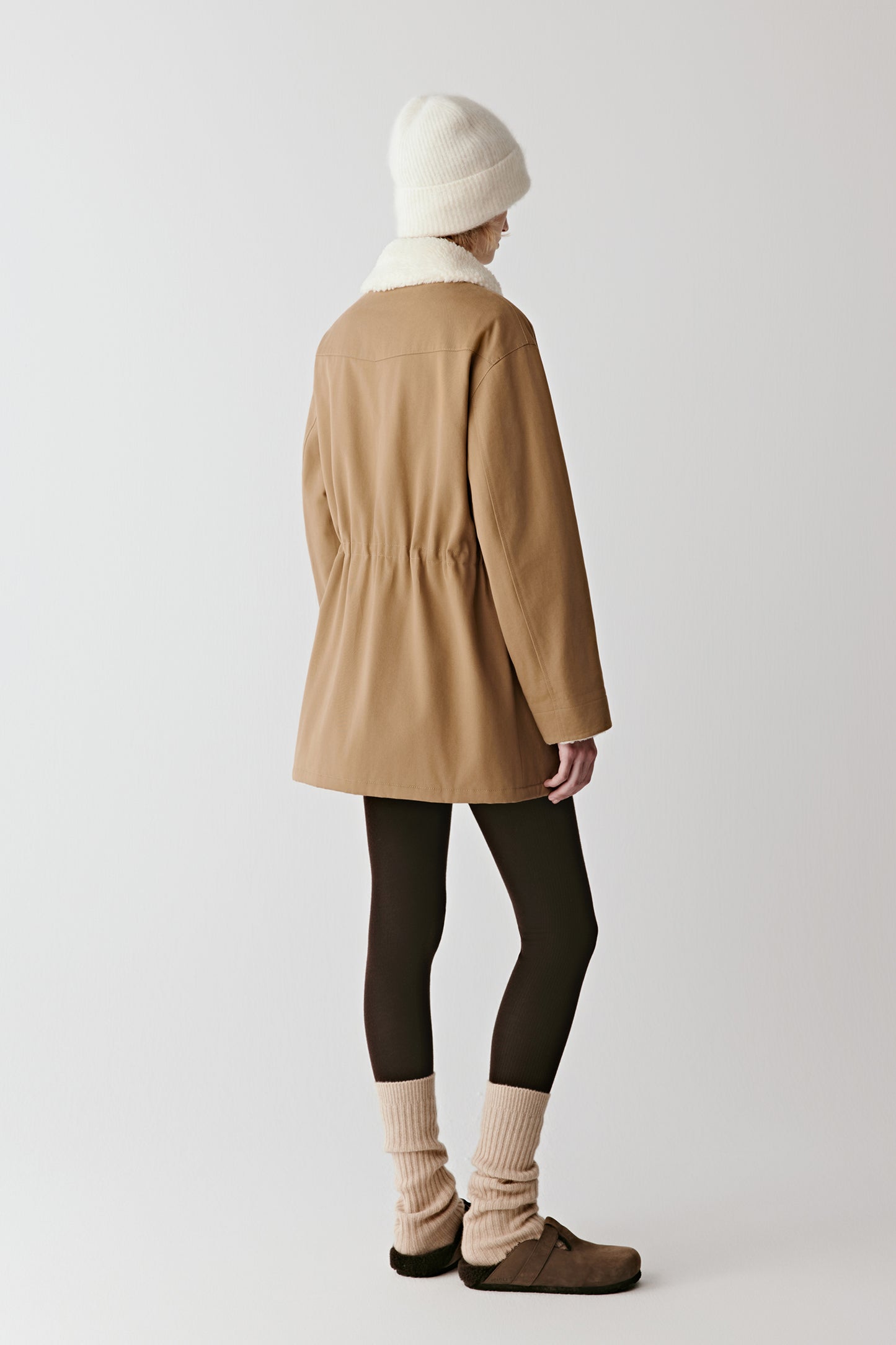 Back view of the camel cotton twill parka, showing the straight hem and long silhouette.