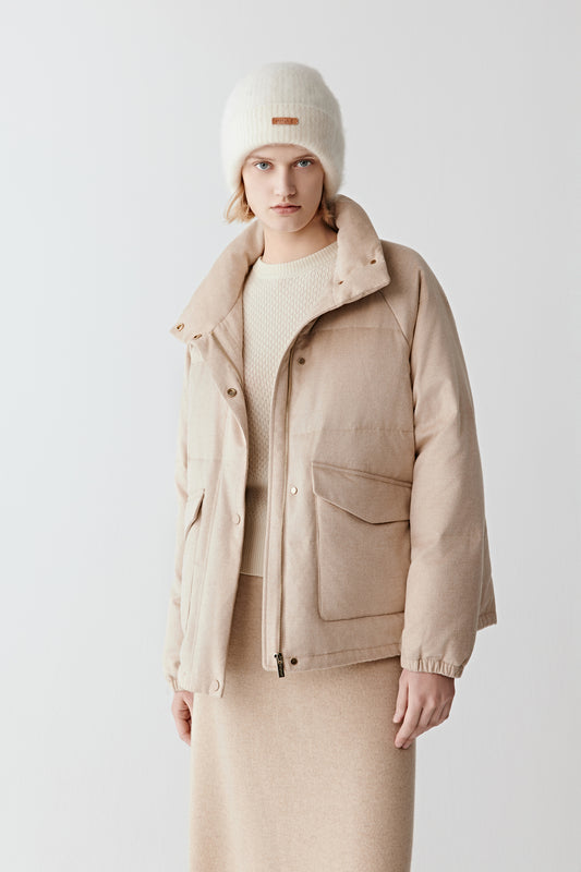 Three-quarter view of the camel silk tweed down coat, highlighting the flap pockets, streamlined cut, and soft natural shade.